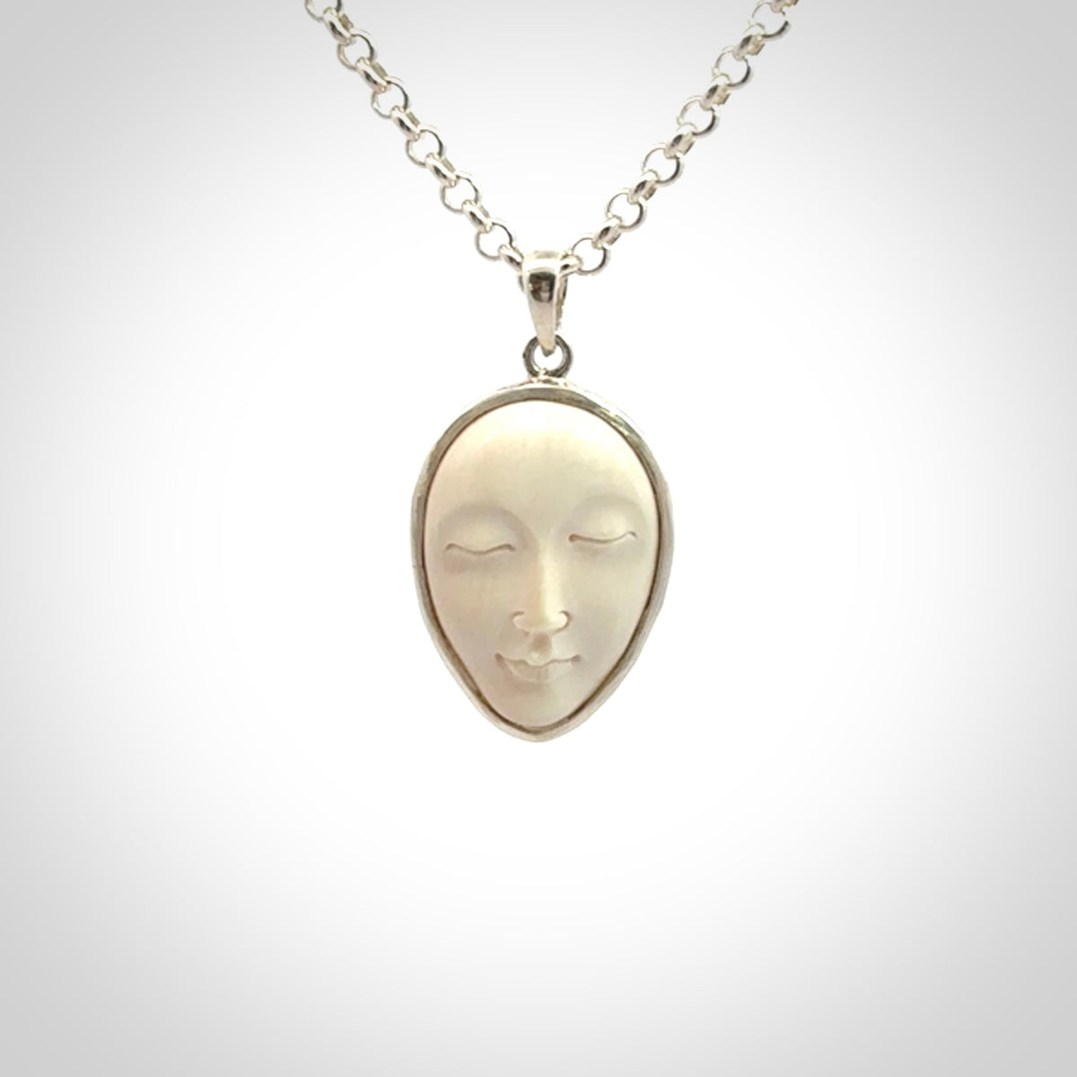 Hand made woolly mammoth tusk moon face necklace. Made by NZ Pacific and sale online only.