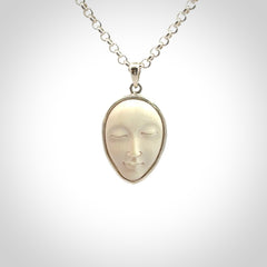 Hand made woolly mammoth tusk moon face necklace. Made by NZ Pacific and sale online only.