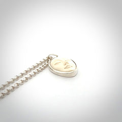 Hand made woolly mammoth tusk moon face necklace. Made by NZ Pacific and sale online only.