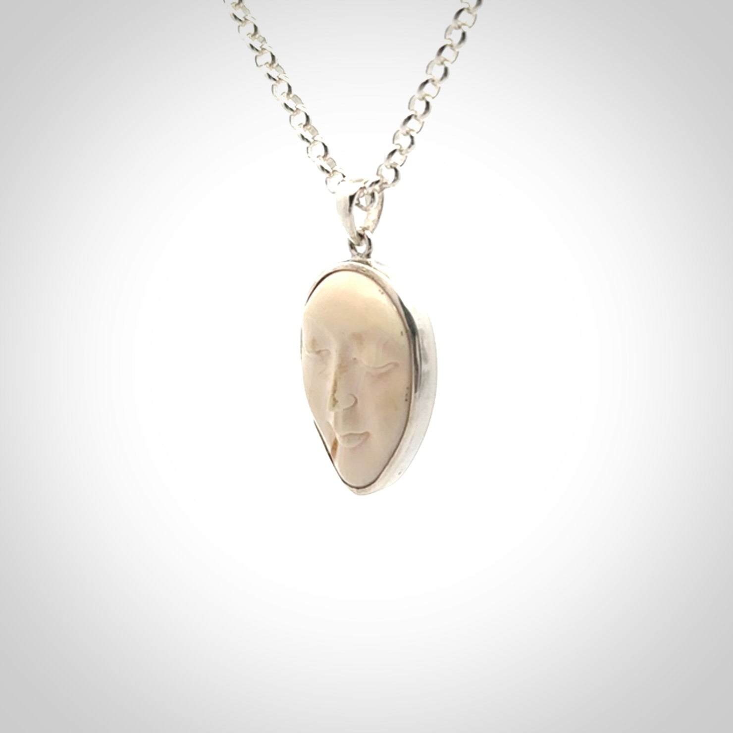 Hand made woolly mammoth tusk moon face necklace. Made by NZ Pacific and sale online only.