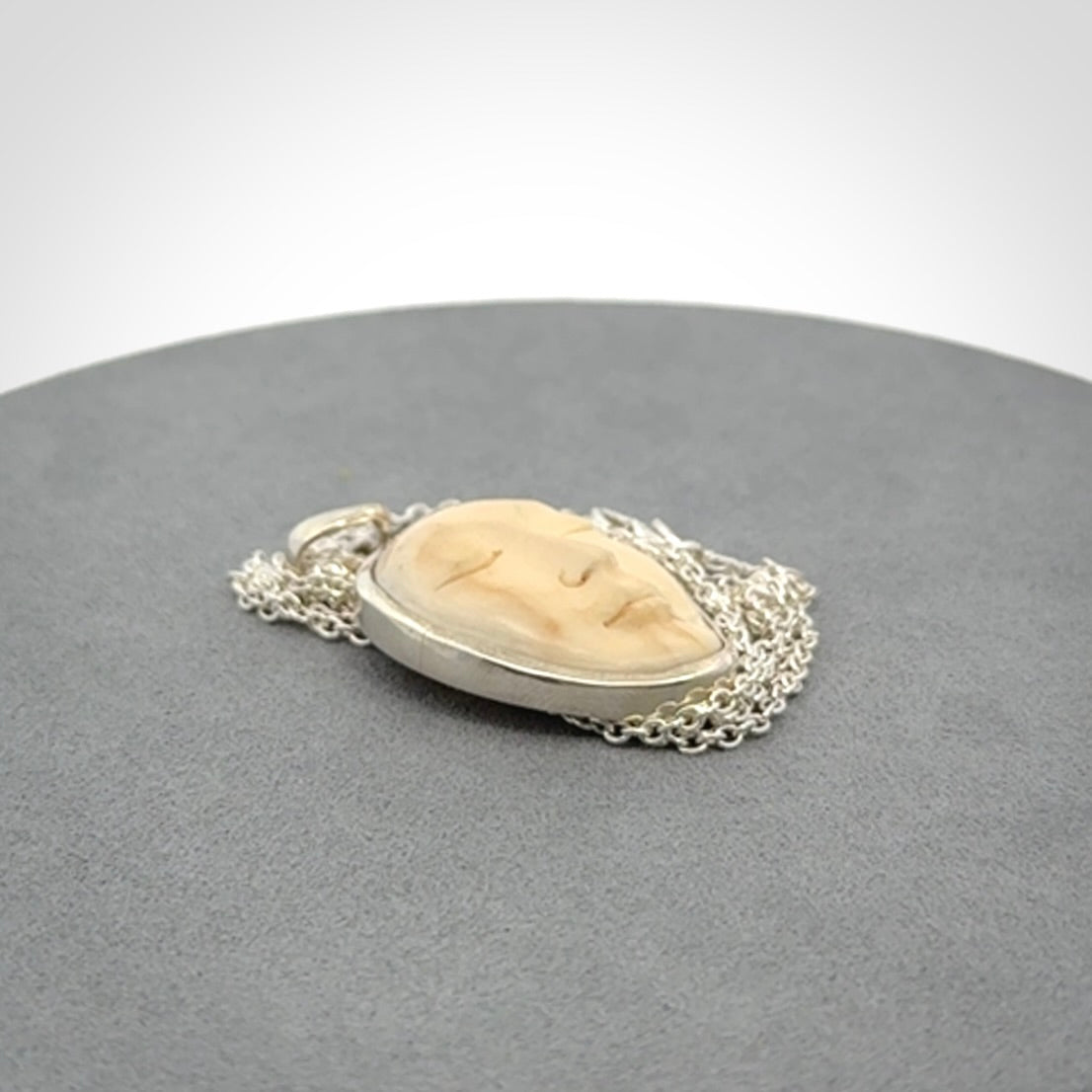 Hand made woolly mammoth tusk moon face necklace. Made by NZ Pacific and sale online only.