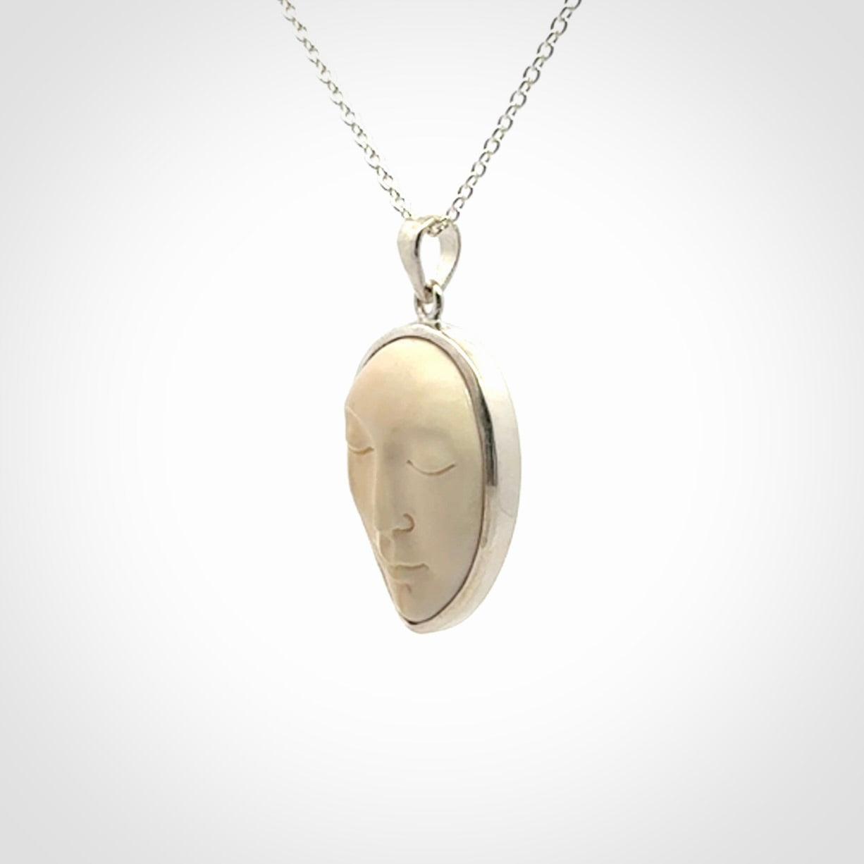 Hand made woolly mammoth tusk moon face necklace. Made by NZ Pacific and sale online only.