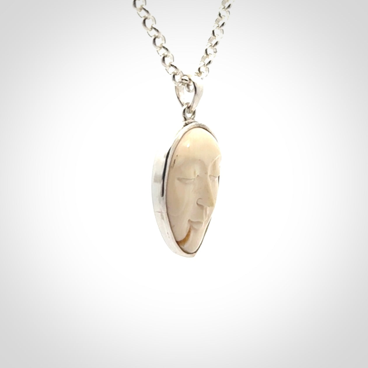 Hand made woolly mammoth tusk moon face necklace. Made by NZ Pacific and sale online only.