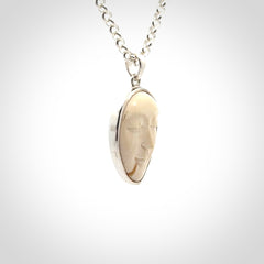 Hand made woolly mammoth tusk moon face necklace. Made by NZ Pacific and sale online only.