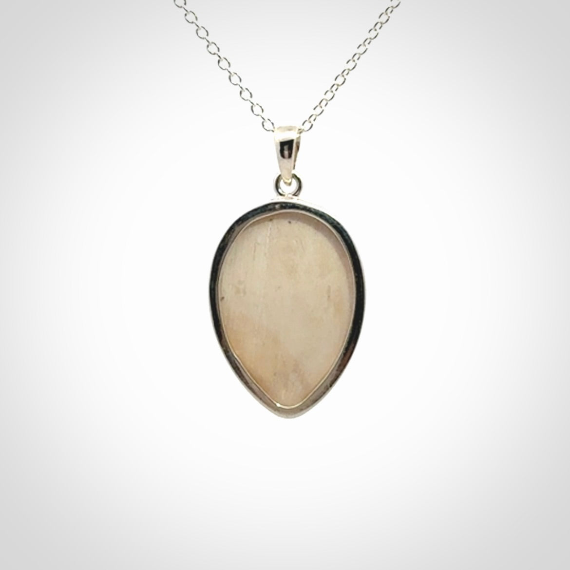 Hand made woolly mammoth tusk moon face necklace. Made by NZ Pacific and sale online only.