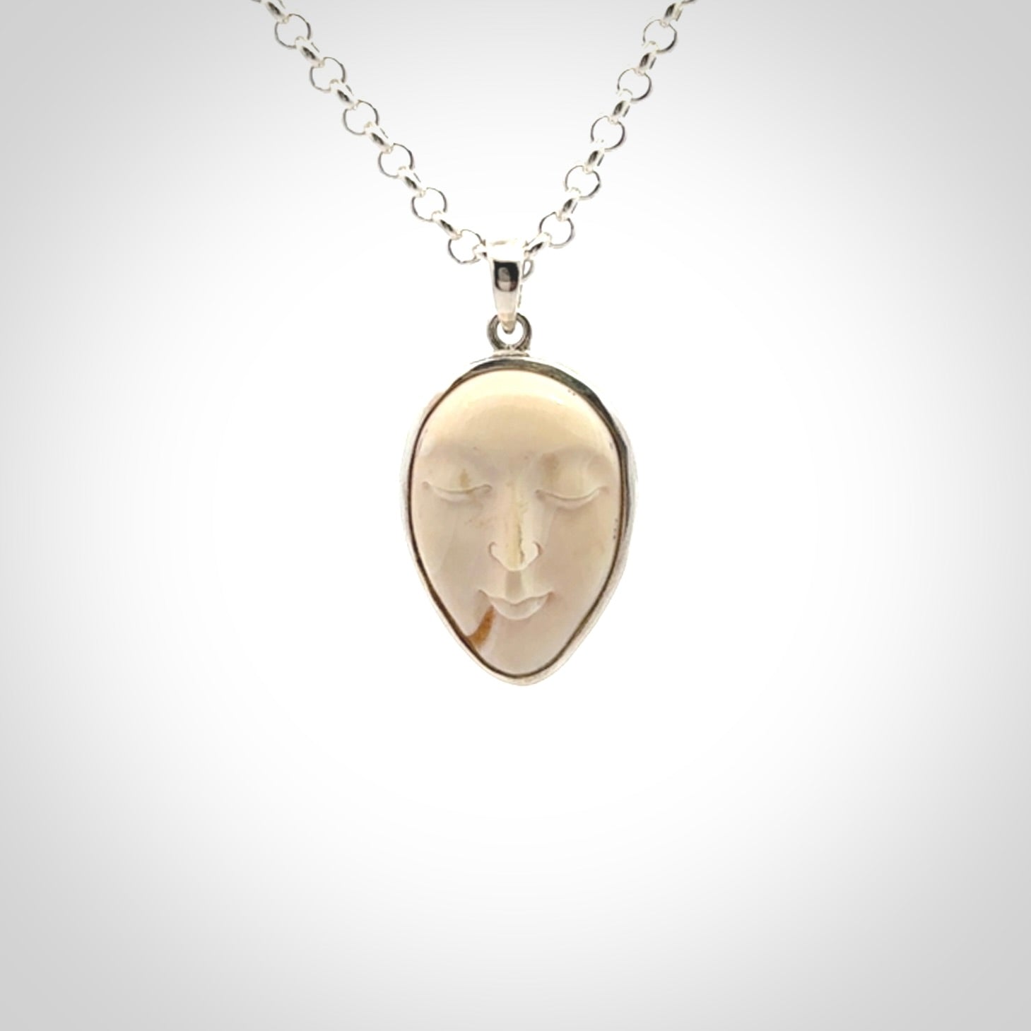 Hand made woolly mammoth tusk moon face necklace. Made by NZ Pacific and sale online only.