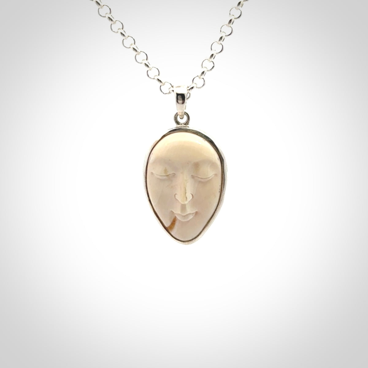 Hand made woolly mammoth tusk moon face necklace. Made by NZ Pacific and sale online only.