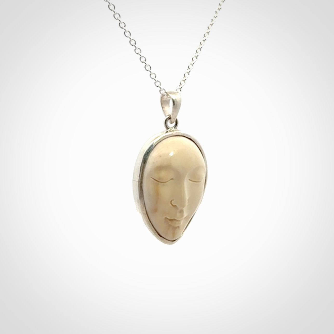 Hand made woolly mammoth tusk moon face necklace. Made by NZ Pacific and sale online only.