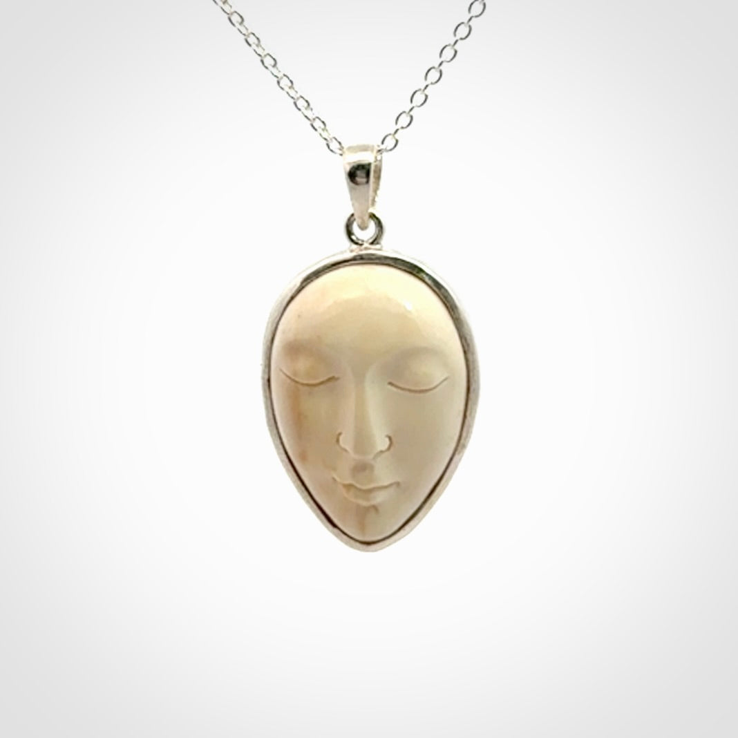 Hand made woolly mammoth tusk moon face necklace. Made by NZ Pacific and sale online only.