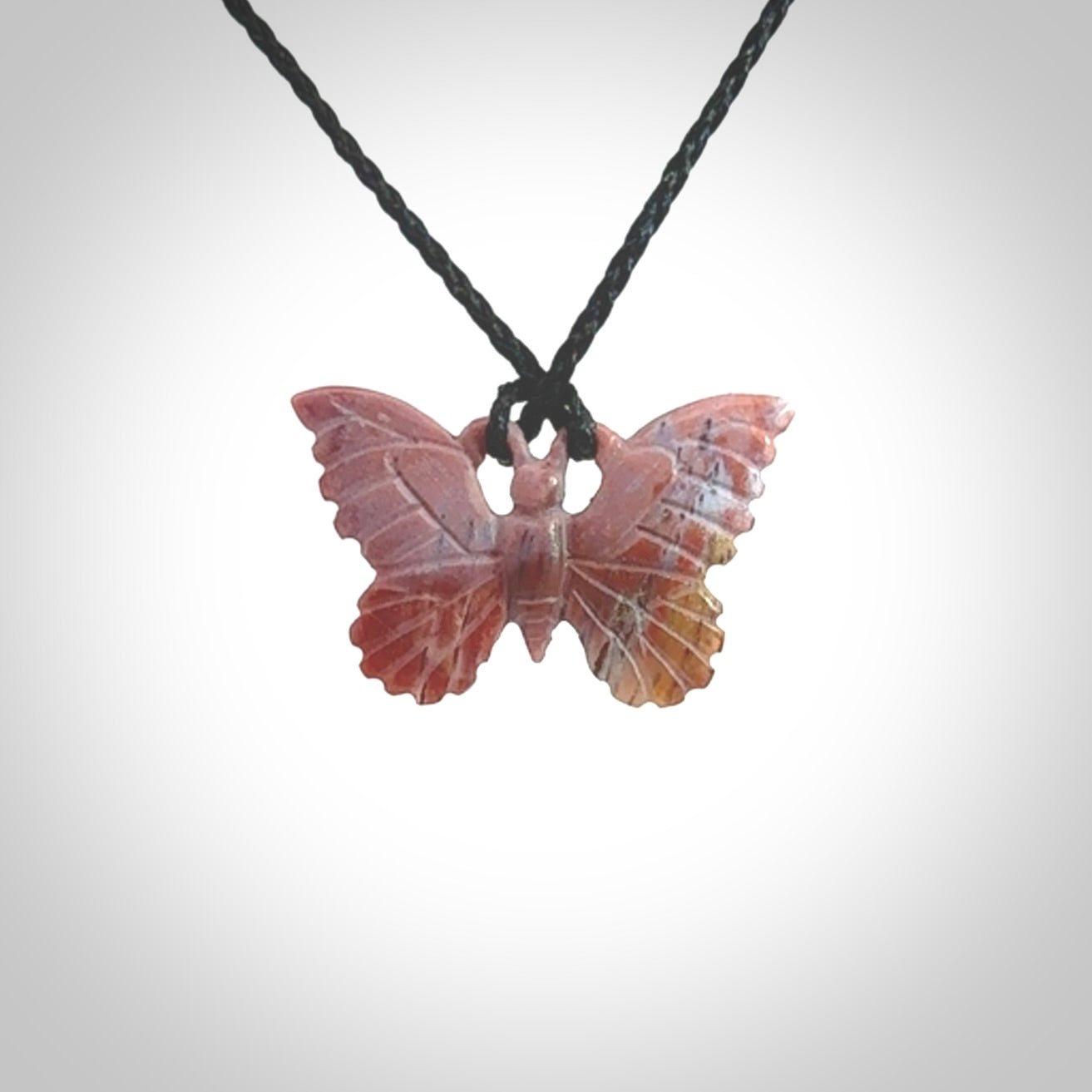 Small Butterfly design pendant carved in Red Agate. Real Agate jewellery for sale online with NZ Pacific. Small butterfly pendant hand made in red agate, provided with adjustable cord and packaged in a woven kete pouch.