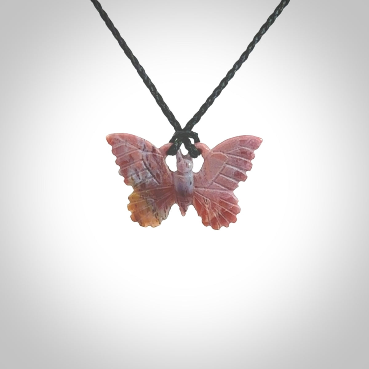 Small Butterfly design pendant carved in Red Agate. Real Agate jewellery for sale online with NZ Pacific. Small butterfly pendant hand made in red agate, provided with adjustable cord and packaged in a woven kete pouch.