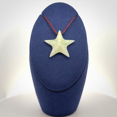 Small Jadeite star pendant. Star shaped necklace hand made from white Jadeite stone. Delivered on an adjustable plum coloured cord and packaged in a woven kete pouch.