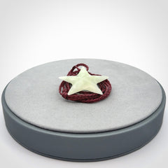 Small Jadeite star pendant. Star shaped necklace hand made from white Jadeite stone. Delivered on an adjustable plum coloured cord and packaged in a woven kete pouch.
