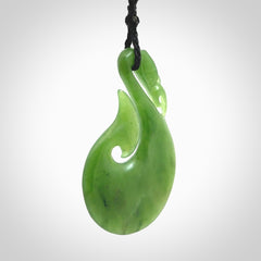 A New Zealand jade manaia necklace carved in lovely green New Zealand jade. The pendant is suspended from a plaited cord. The cord is length adjustable so you can position the pendant where it suits you best. One only Ross Crump Manaia with hook pendant.