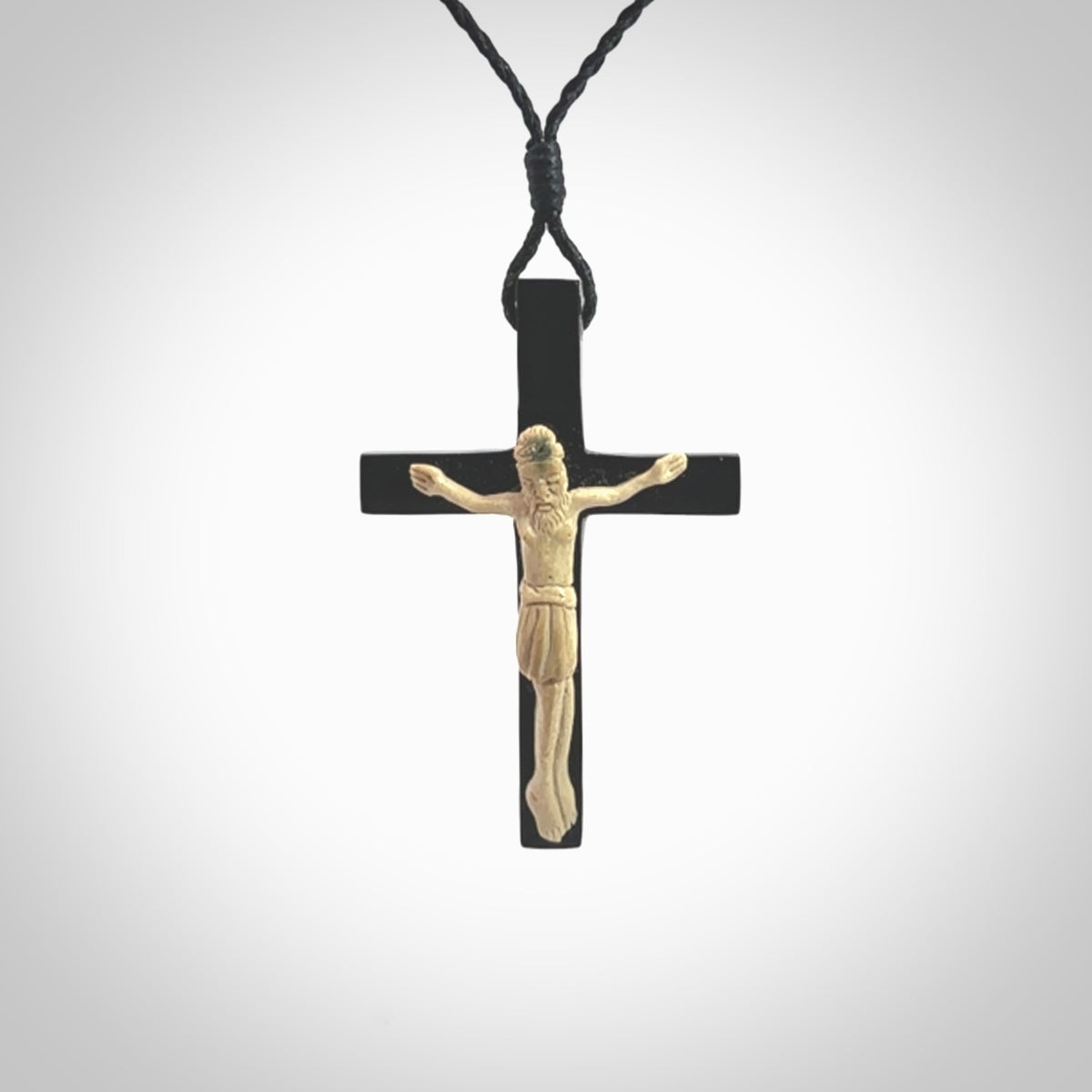 Hand carved black jade crucifix pendant. The cross has been carved from Australian black jade and the Christ from Woolly Mammoth Tusk. This is a beautiful crucifix that has been handmade by NZ Pacific. For sale online and shipping is free.