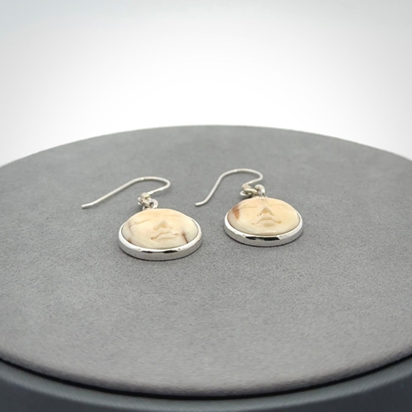 Hand made woolly mammoth tusk moon face earrings. Made by NZ Pacific and sale online only.
