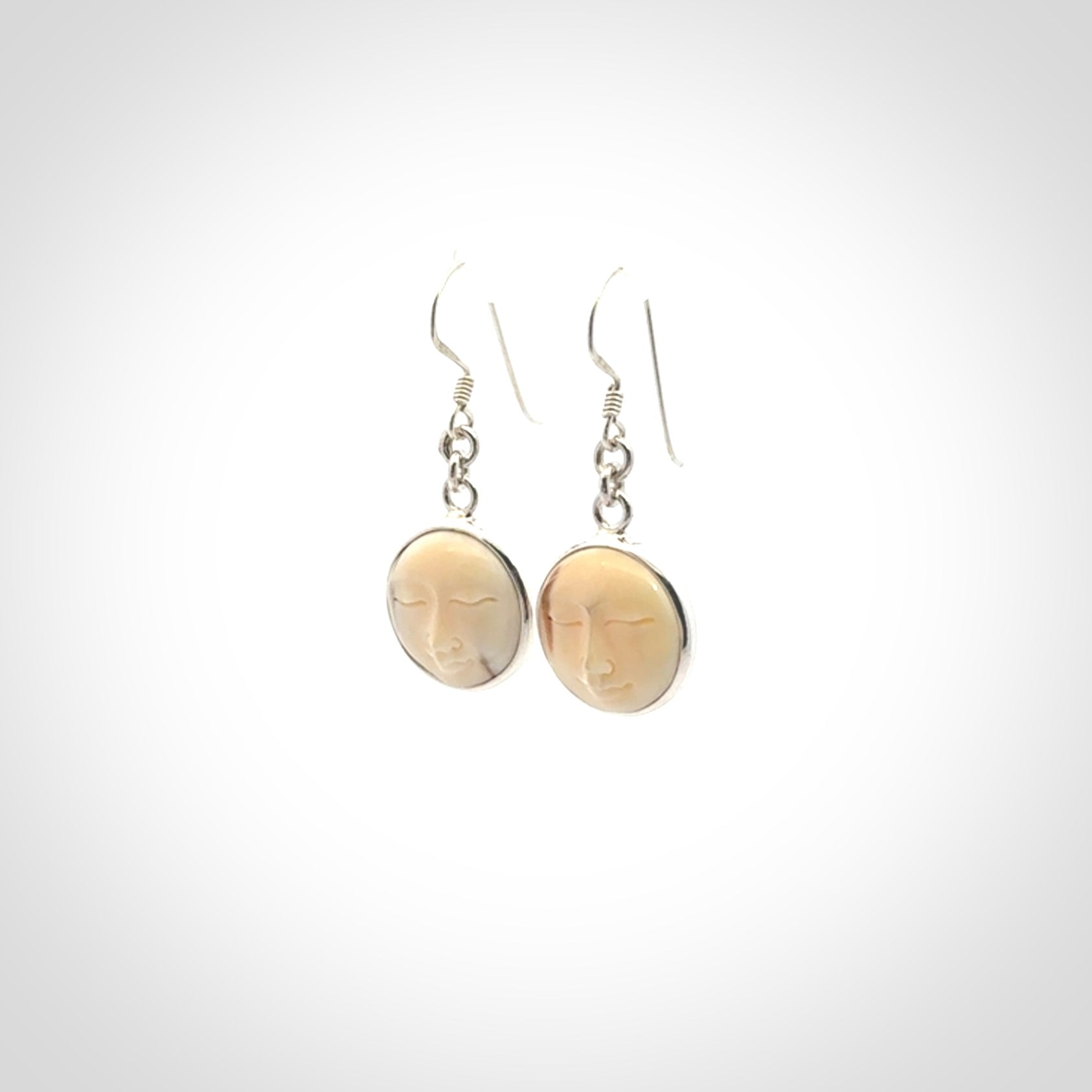 Hand made woolly mammoth tusk moon face earrings. Made by NZ Pacific and sale online only.