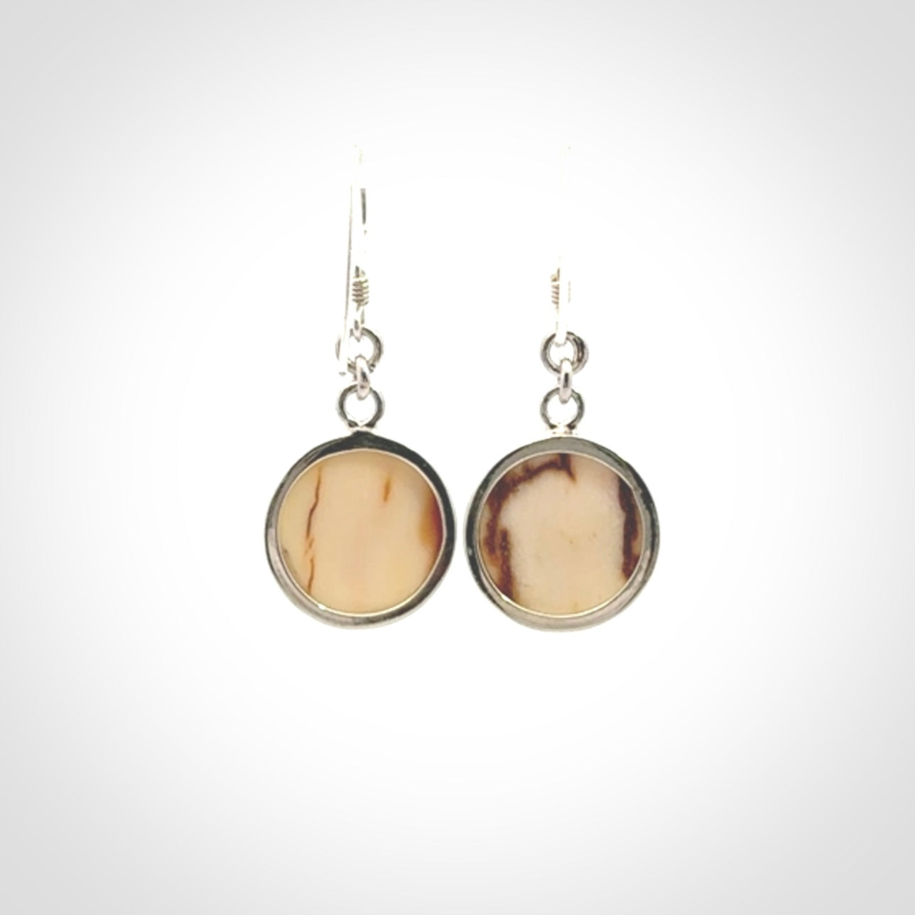 Hand made woolly mammoth tusk moon face earrings. Made by NZ Pacific and sale online only.