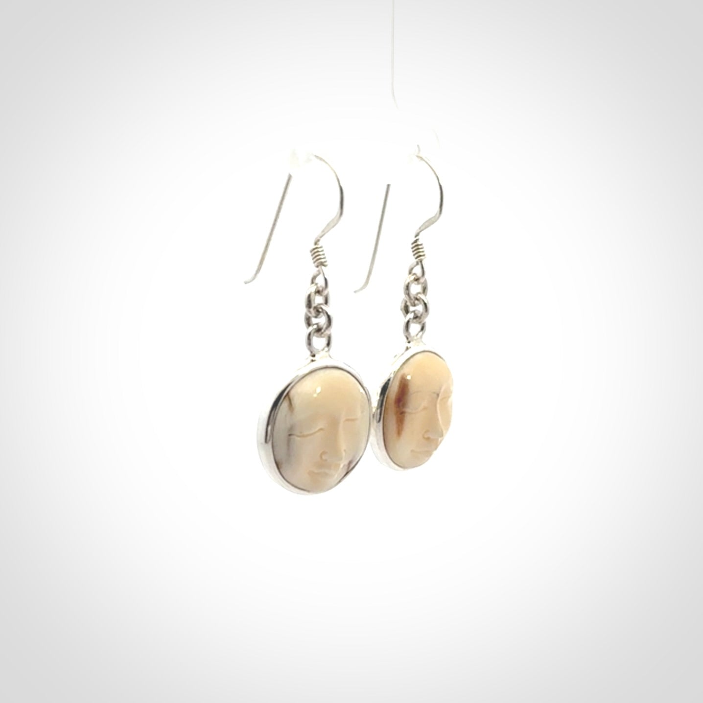 Hand made woolly mammoth tusk moon face earrings. Made by NZ Pacific and sale online only.