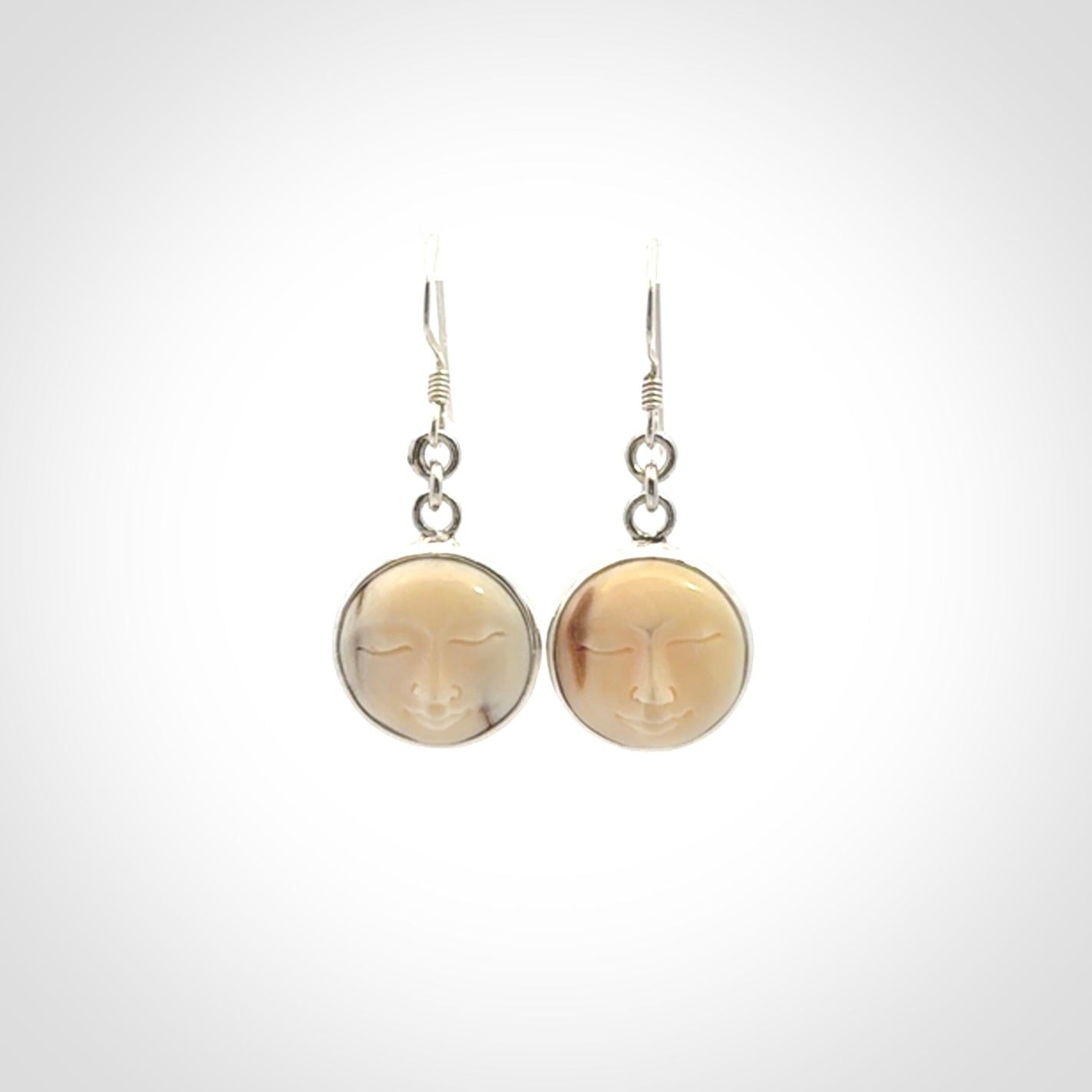 Hand made woolly mammoth tusk moon face earrings. Made by NZ Pacific and sale online only.