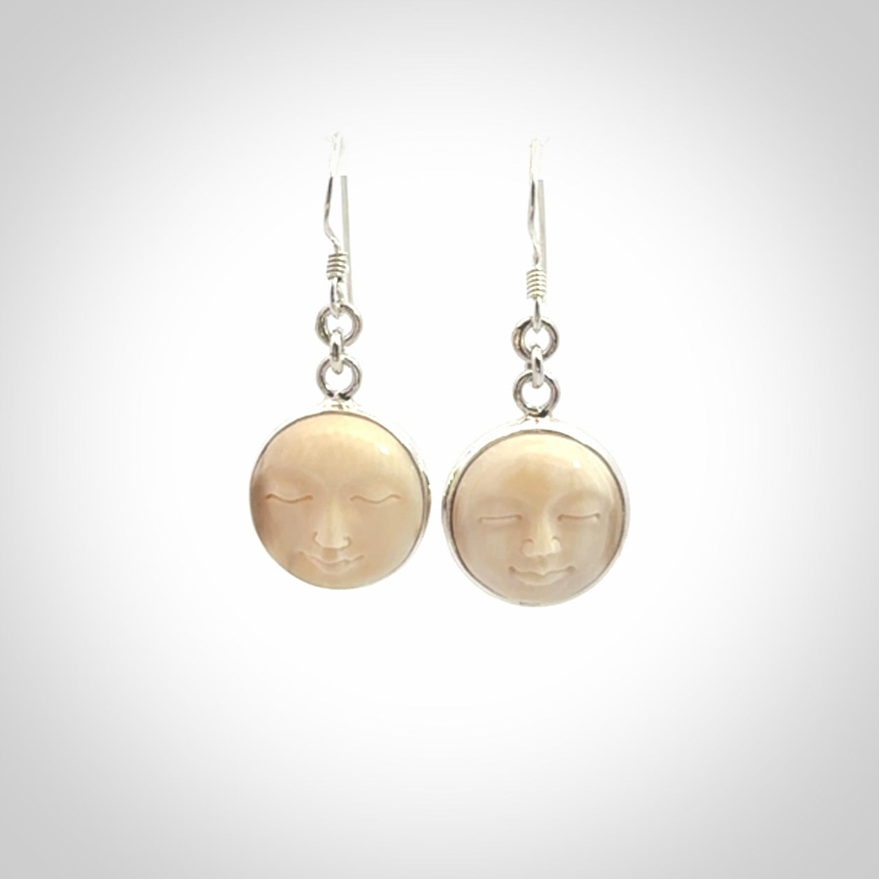 Hand made woolly mammoth tusk moon face earrings. Made by NZ Pacific and sale online only.