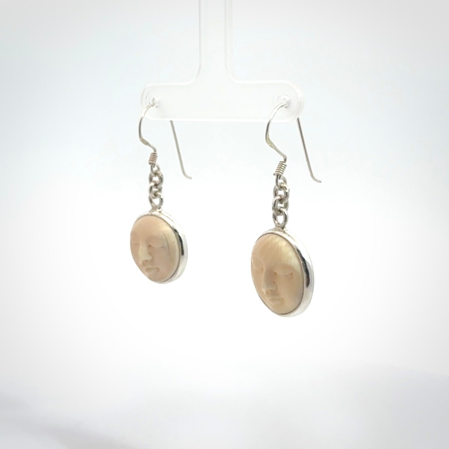 Hand made woolly mammoth tusk moon face earrings. Made by NZ Pacific and sale online only.