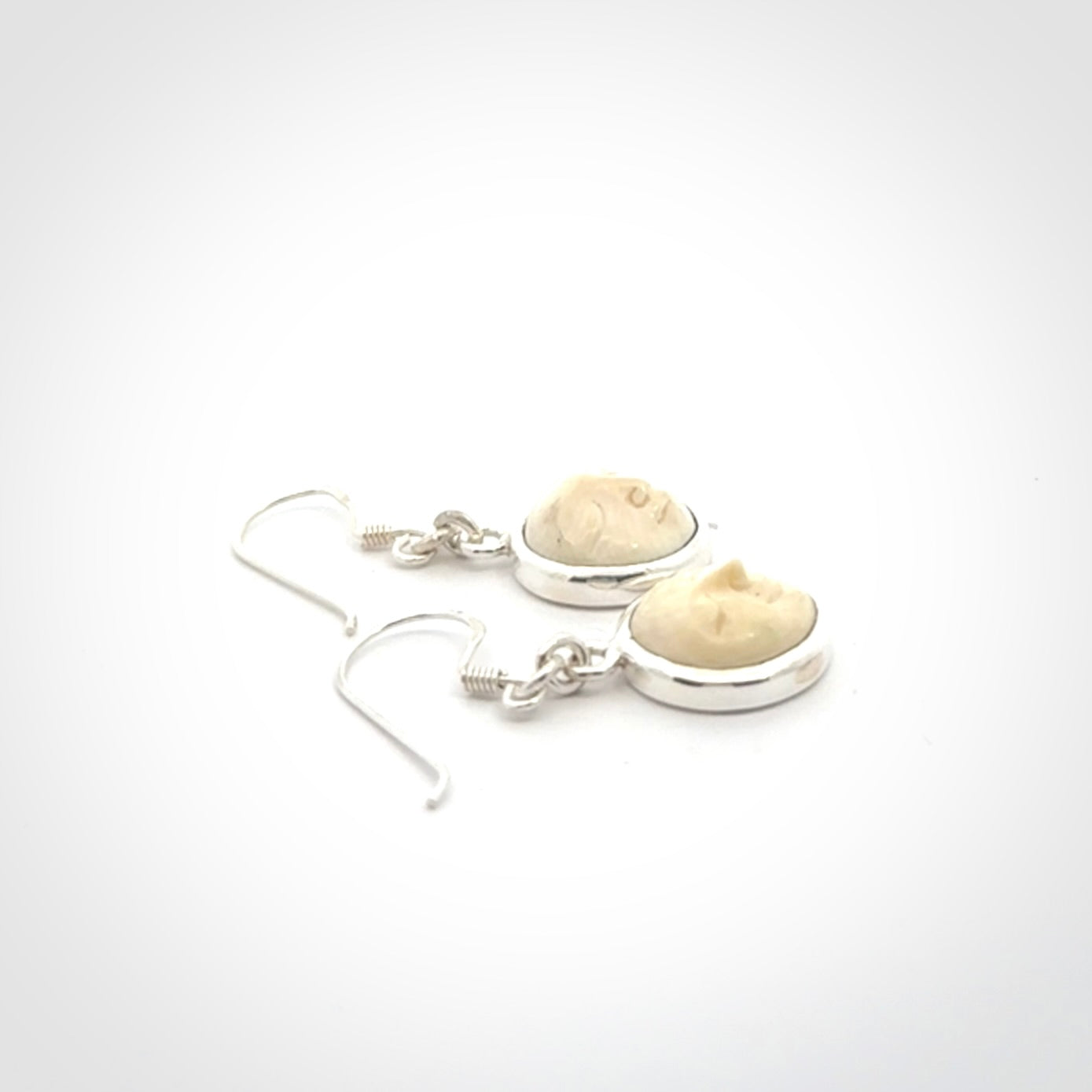 Hand made woolly mammoth tusk moon face earrings. Made by NZ Pacific and sale online only.