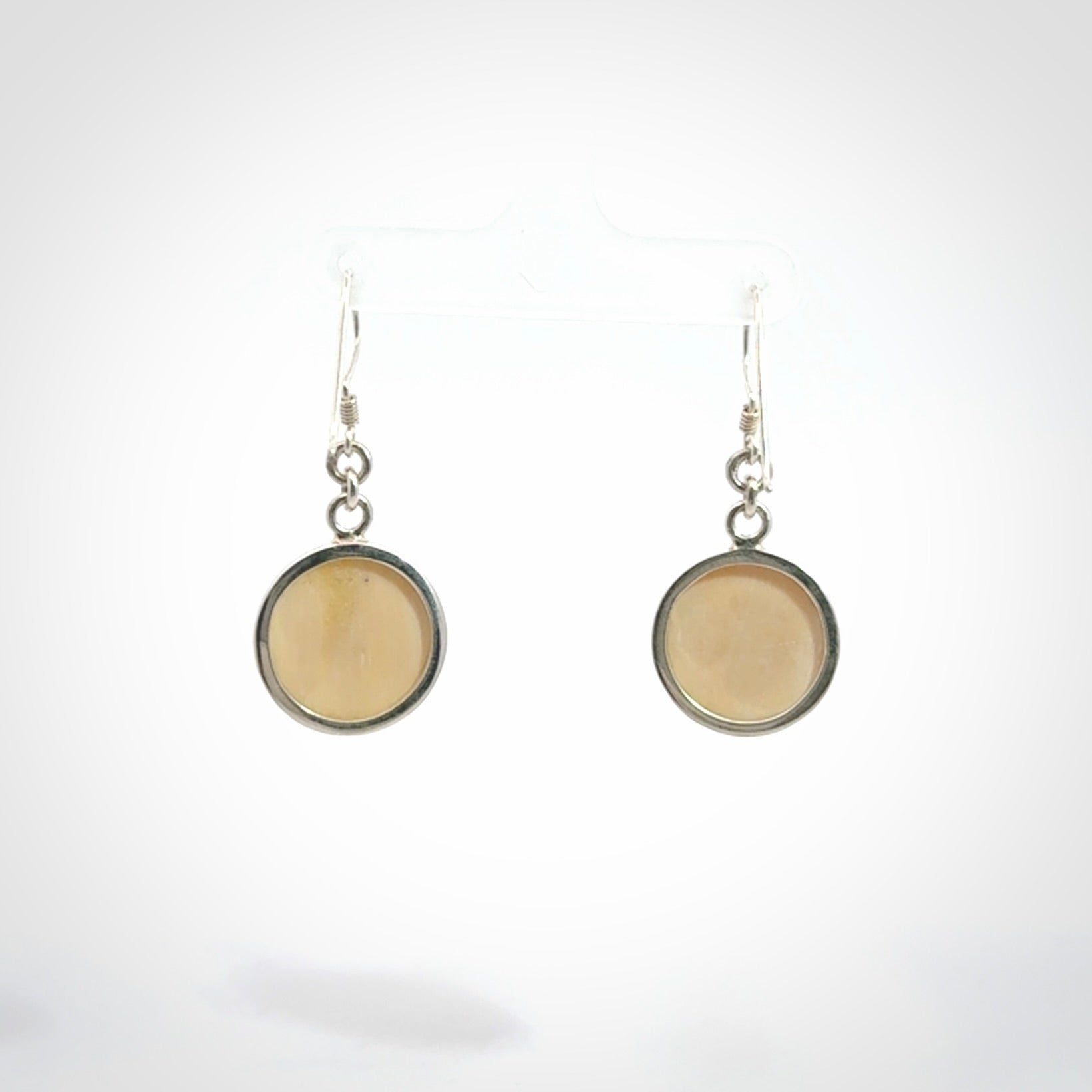 Hand made woolly mammoth tusk moon face earrings. Made by NZ Pacific and sale online only.