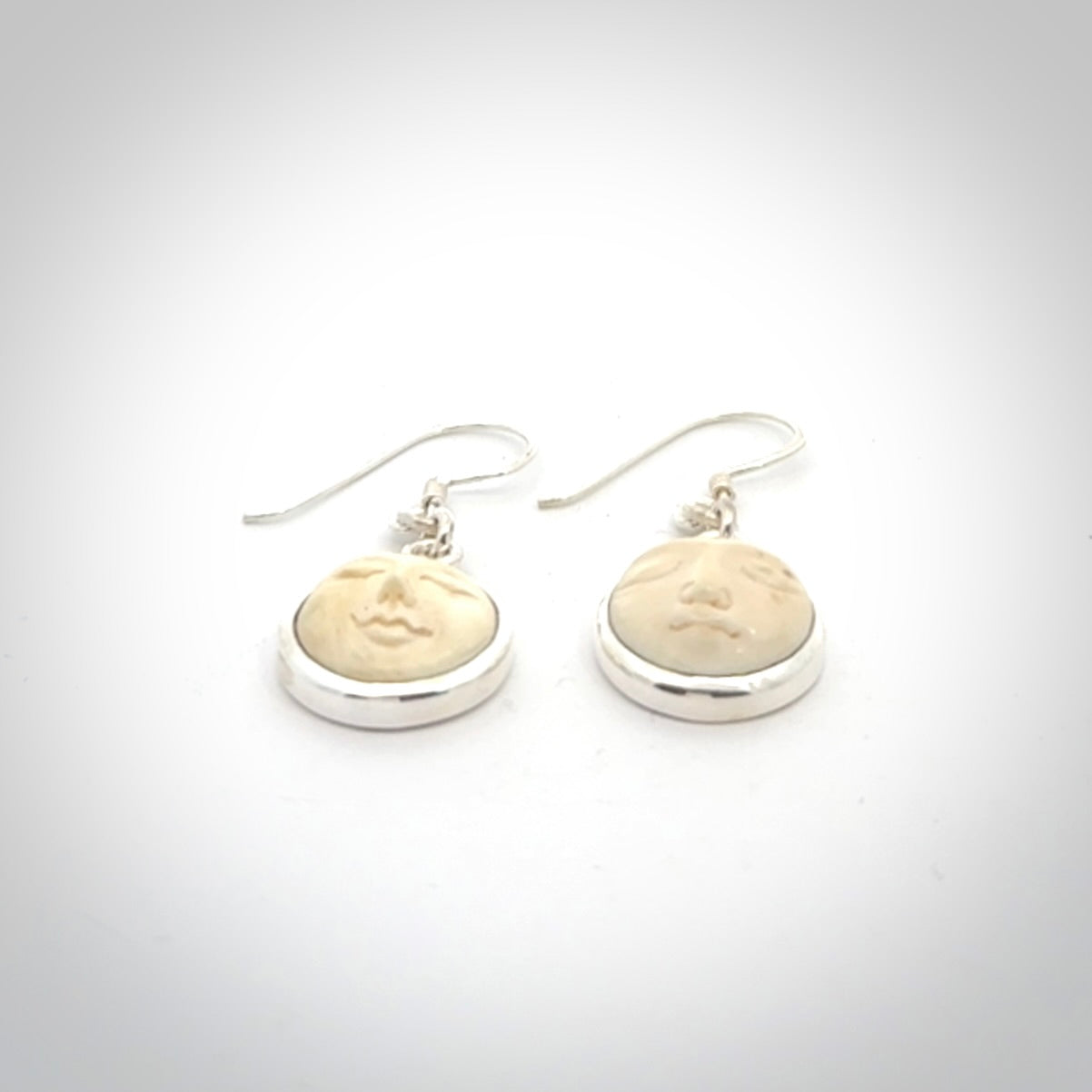 Hand made woolly mammoth tusk moon face earrings. Made by NZ Pacific and sale online only.