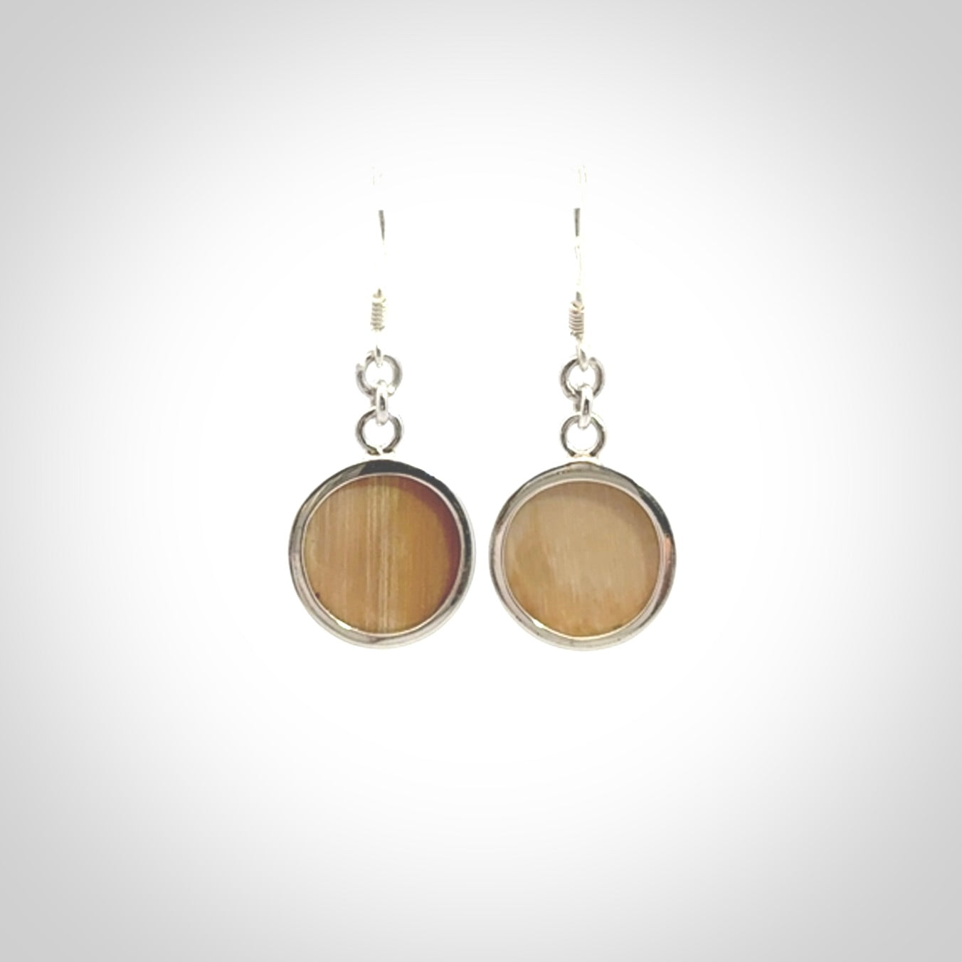Hand made woolly mammoth tusk moon face earrings. Made by NZ Pacific and sale online only.