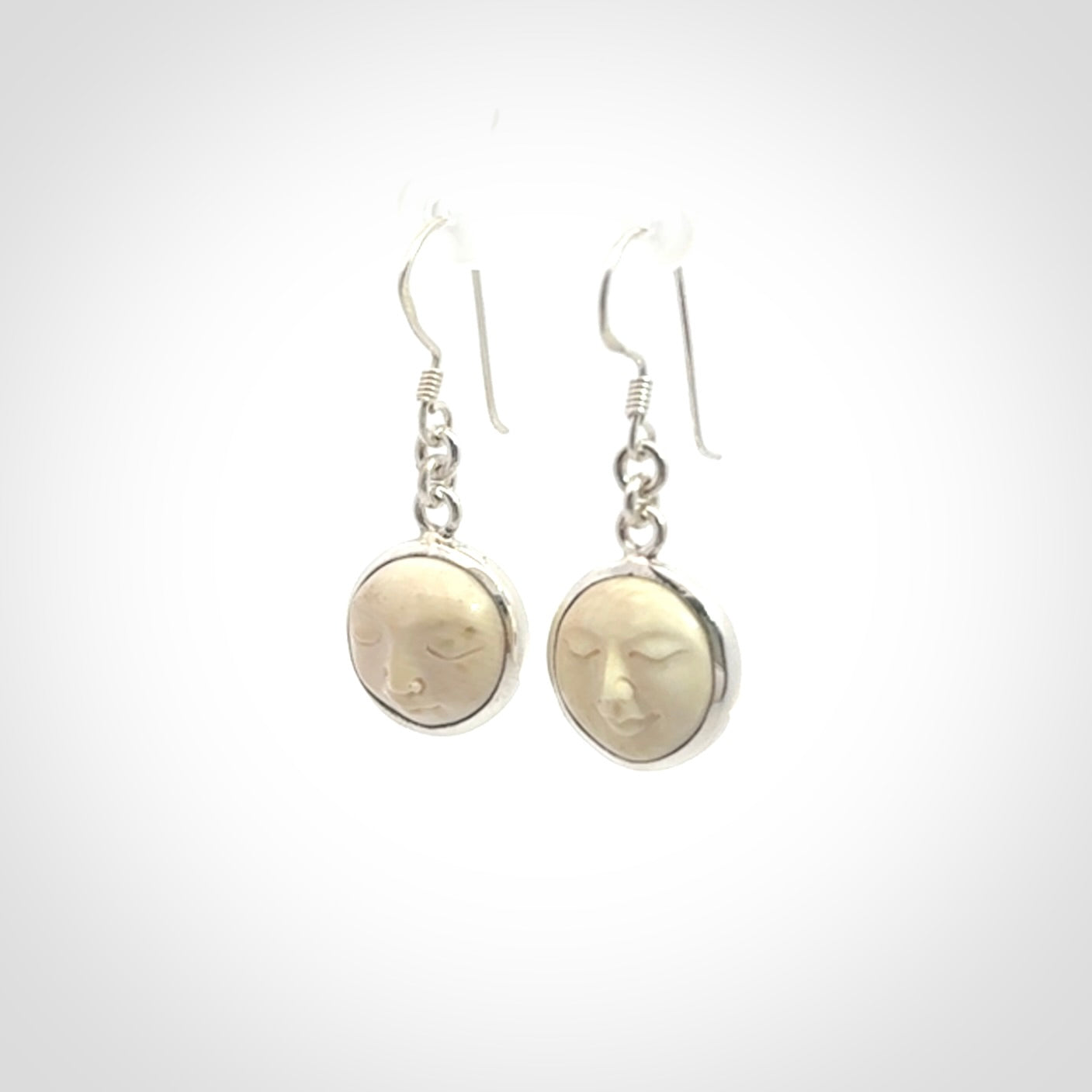 Hand made woolly mammoth tusk moon face earrings. Made by NZ Pacific and sale online only.