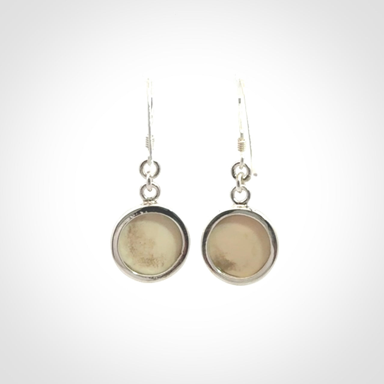 Hand made woolly mammoth tusk moon face earrings. Made by NZ Pacific and sale online only.