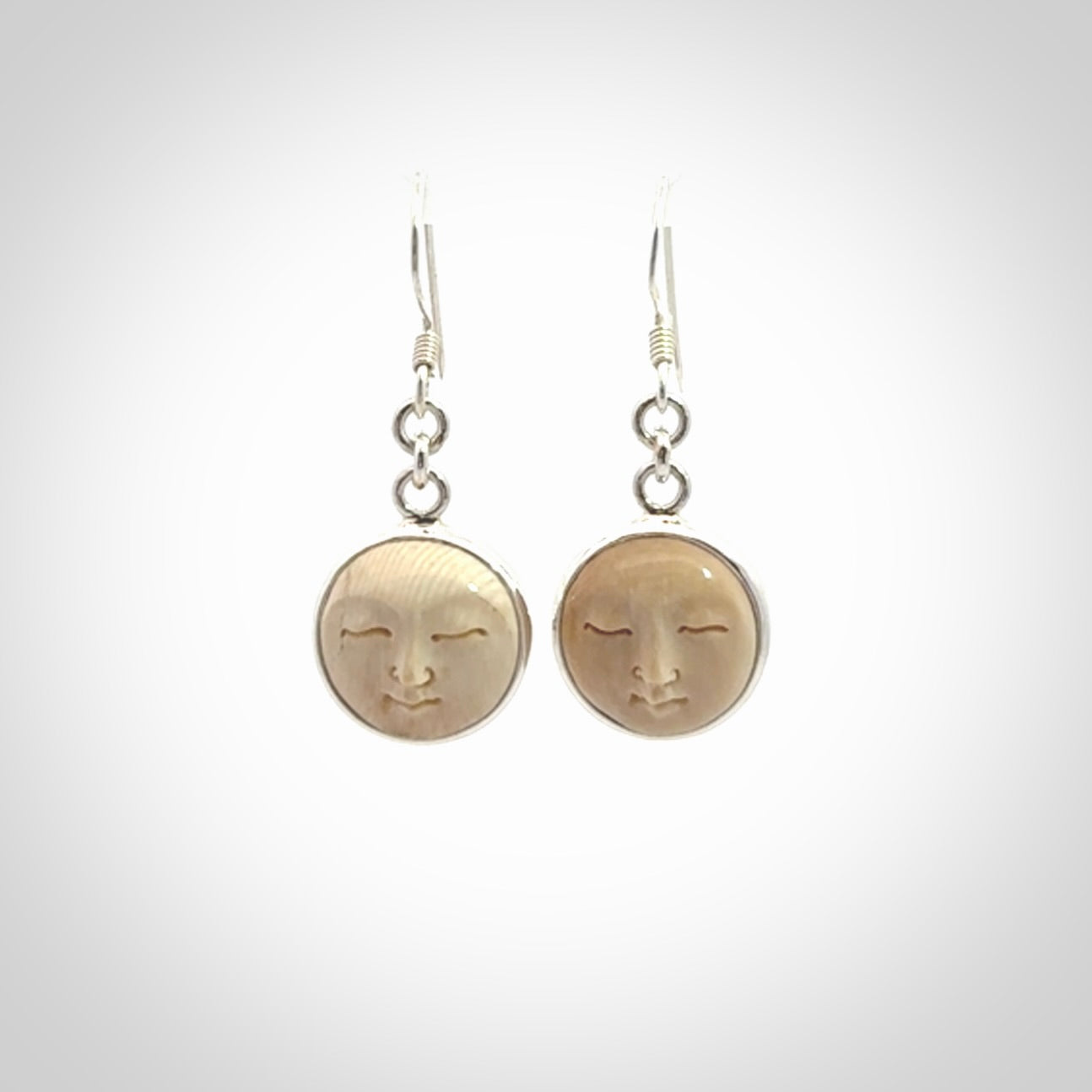 Hand made woolly mammoth tusk moon face earrings. Made by NZ Pacific and sale online only.
