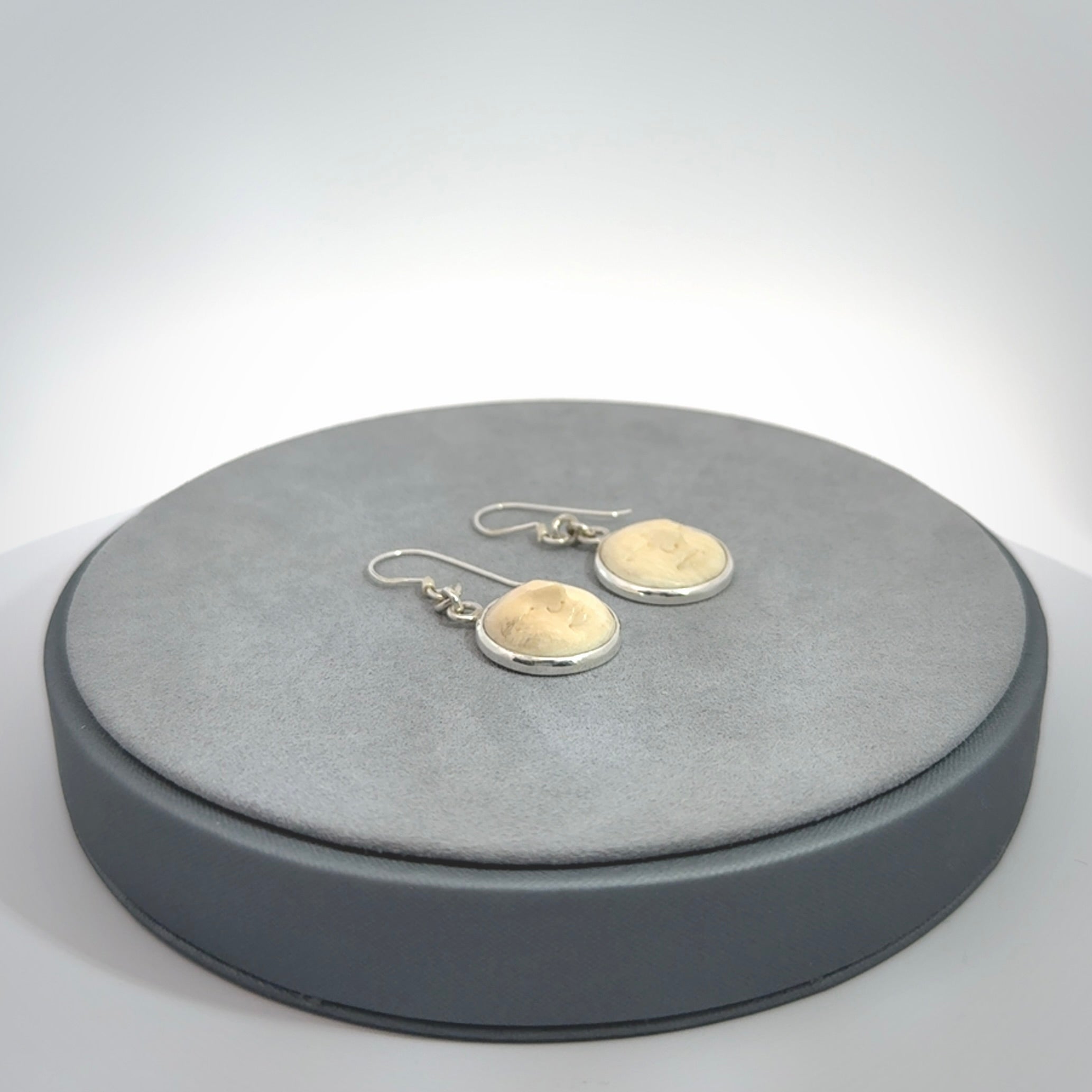 Hand made woolly mammoth tusk moon face earrings. Made by NZ Pacific and sale online only.