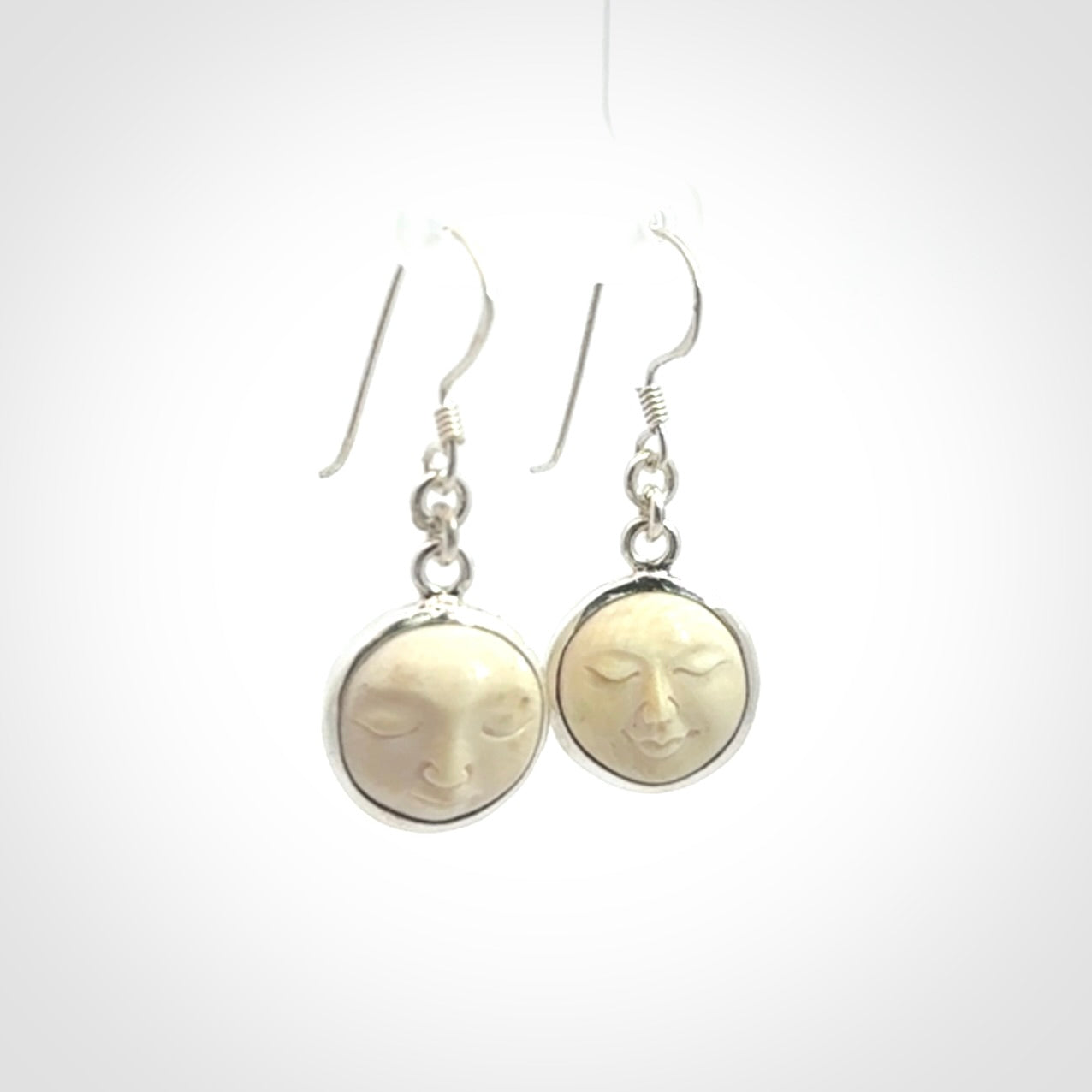 Hand made woolly mammoth tusk moon face earrings. Made by NZ Pacific and sale online only.