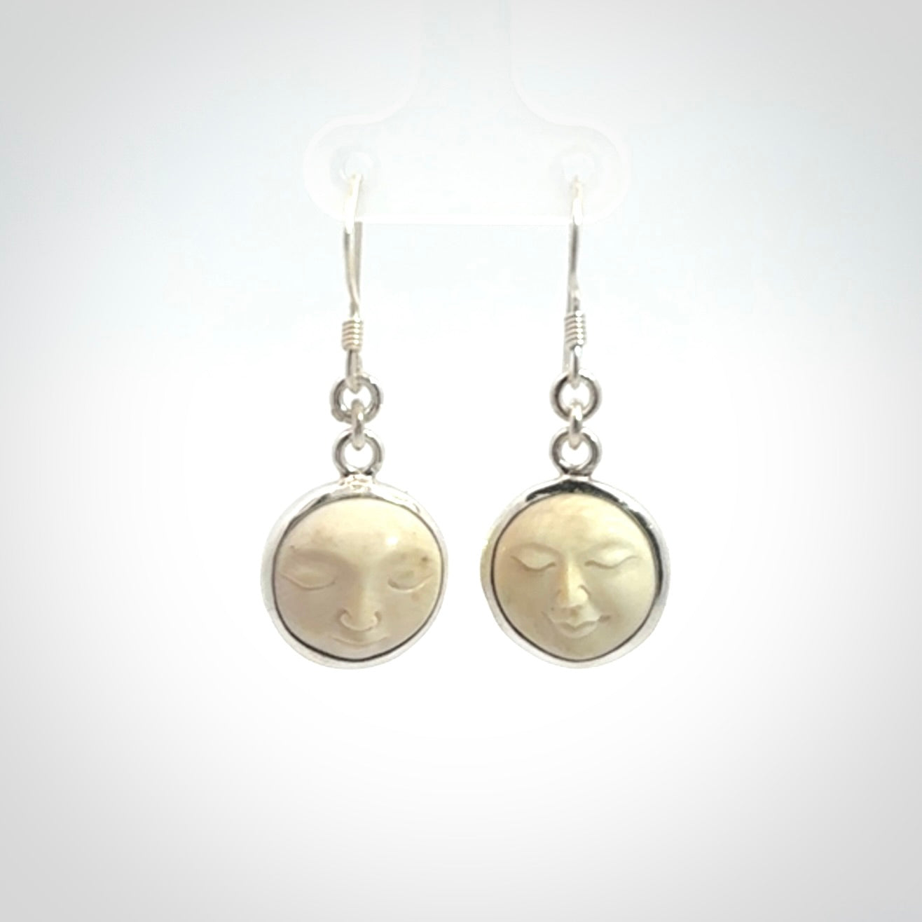 Hand made woolly mammoth tusk moon face earrings. Made by NZ Pacific and sale online only.