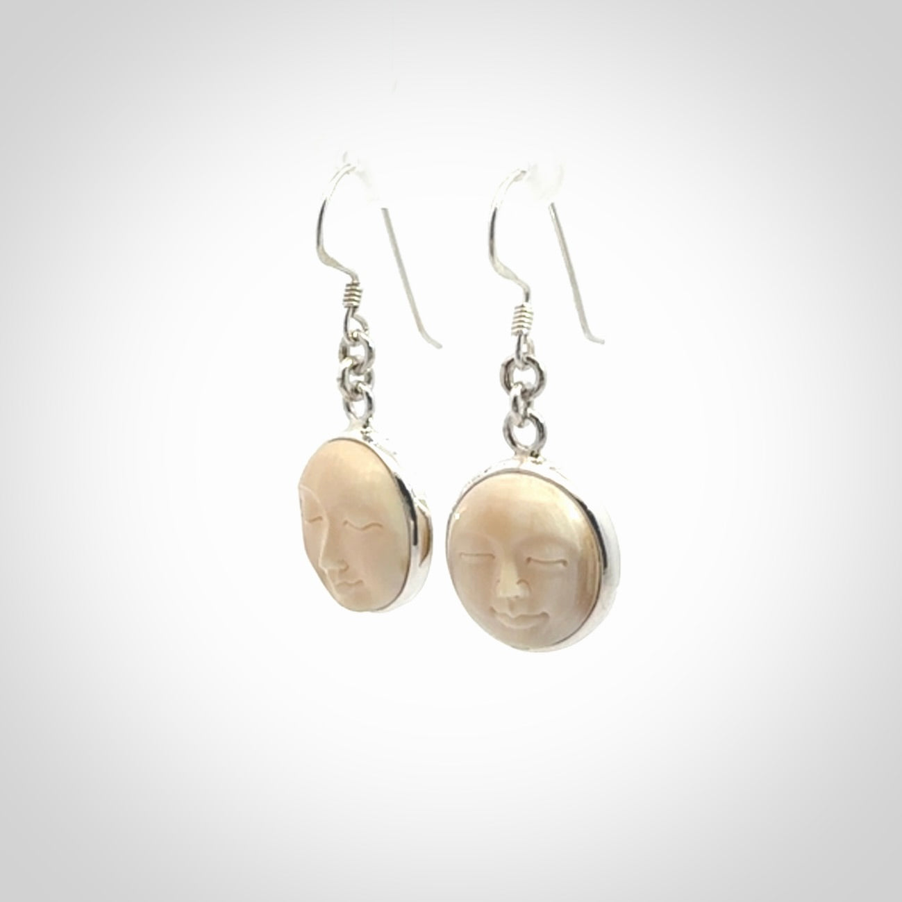 Hand made woolly mammoth tusk moon face earrings. Made by NZ Pacific and sale online only.