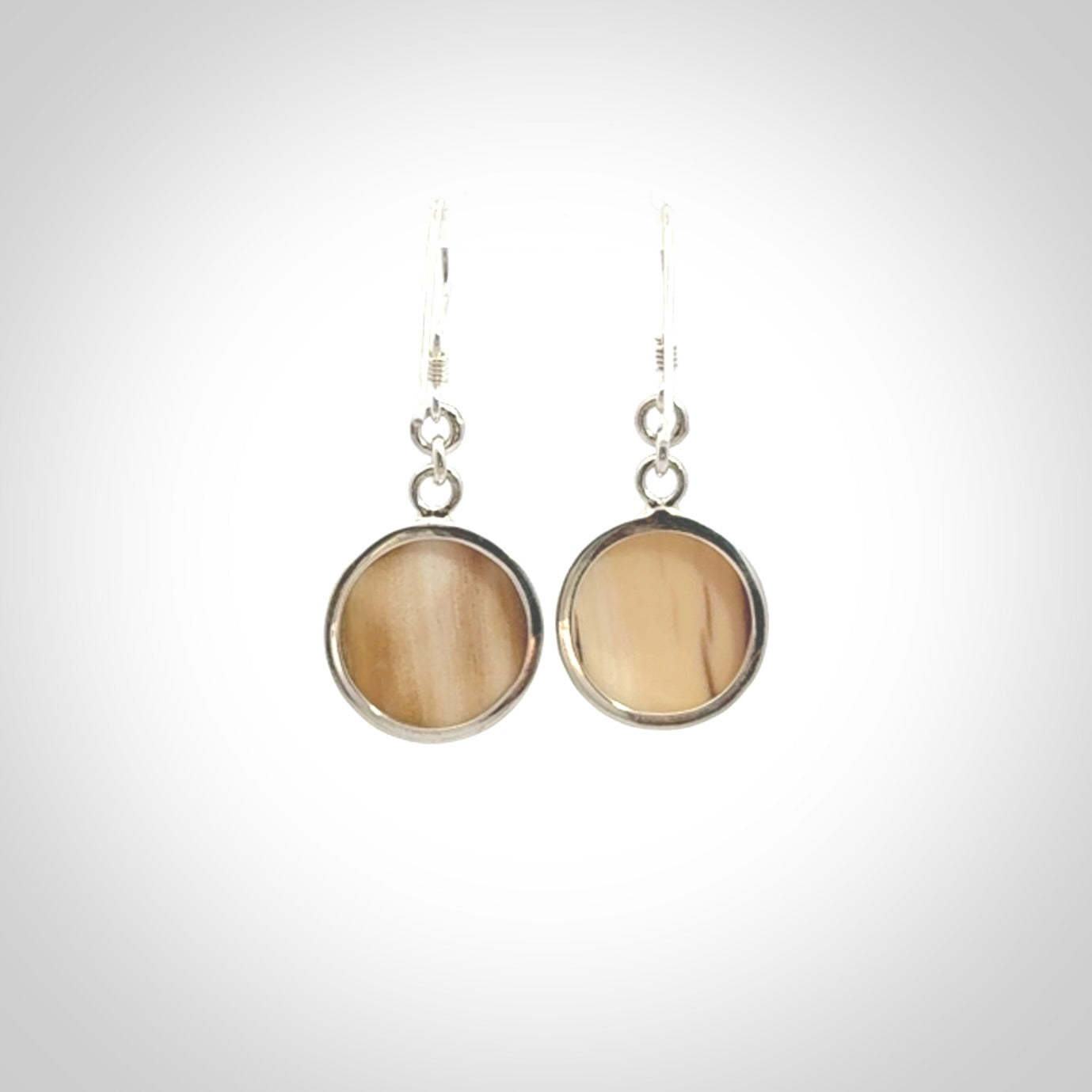Hand made woolly mammoth tusk moon face earrings. Made by NZ Pacific and sale online only.