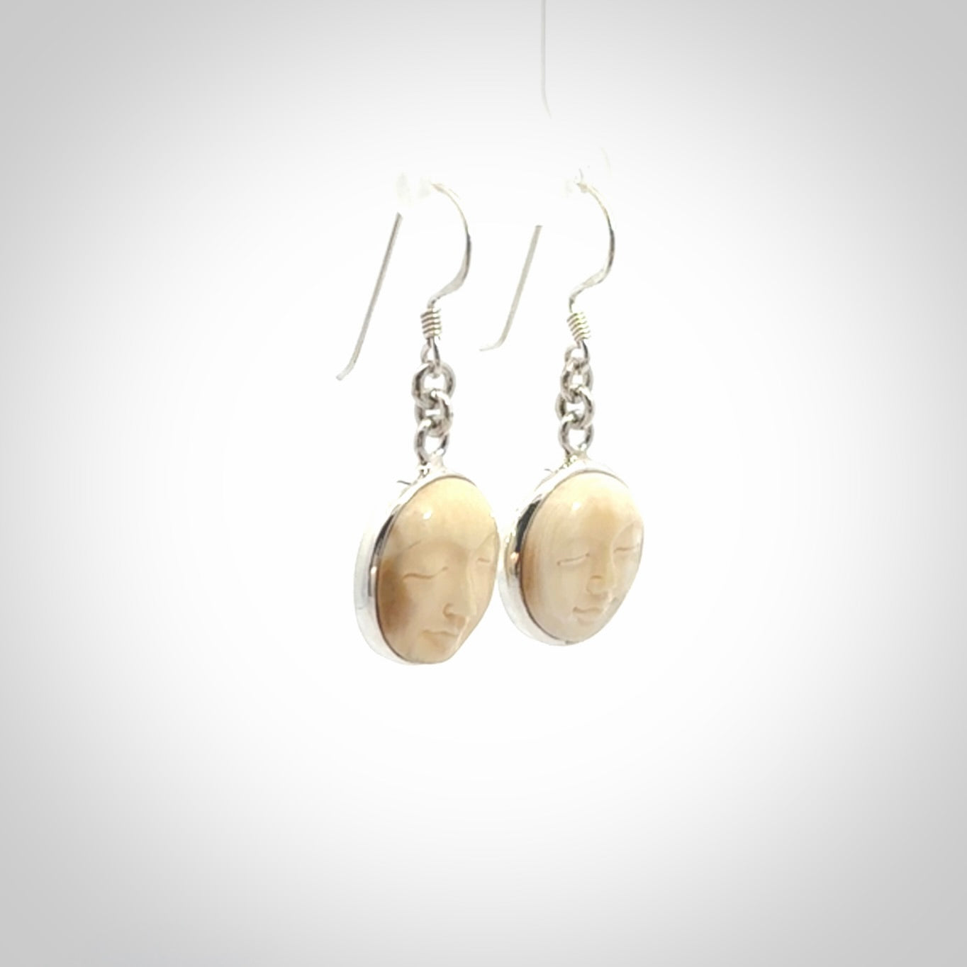 Hand made woolly mammoth tusk moon face earrings. Made by NZ Pacific and sale online only.