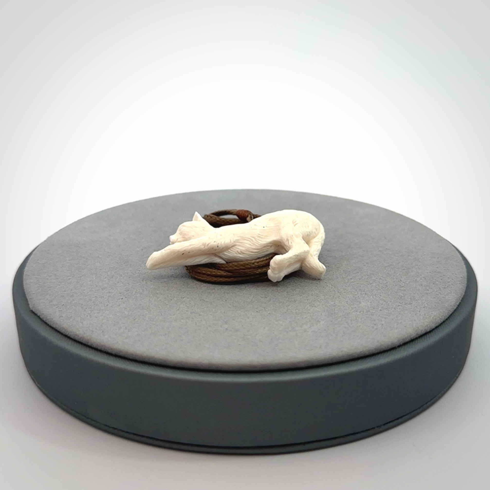 Hand carved bone cat stretching pendant