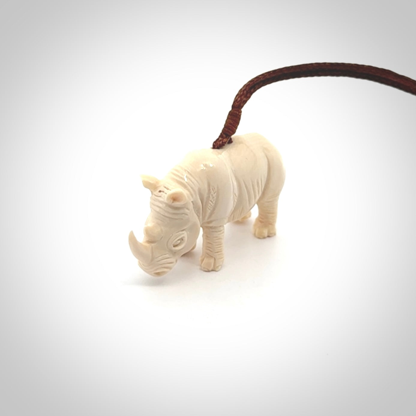 Hand carved Rhinoceros pendant. Carved from woolly mammoth tusk by NZ Pacific.
