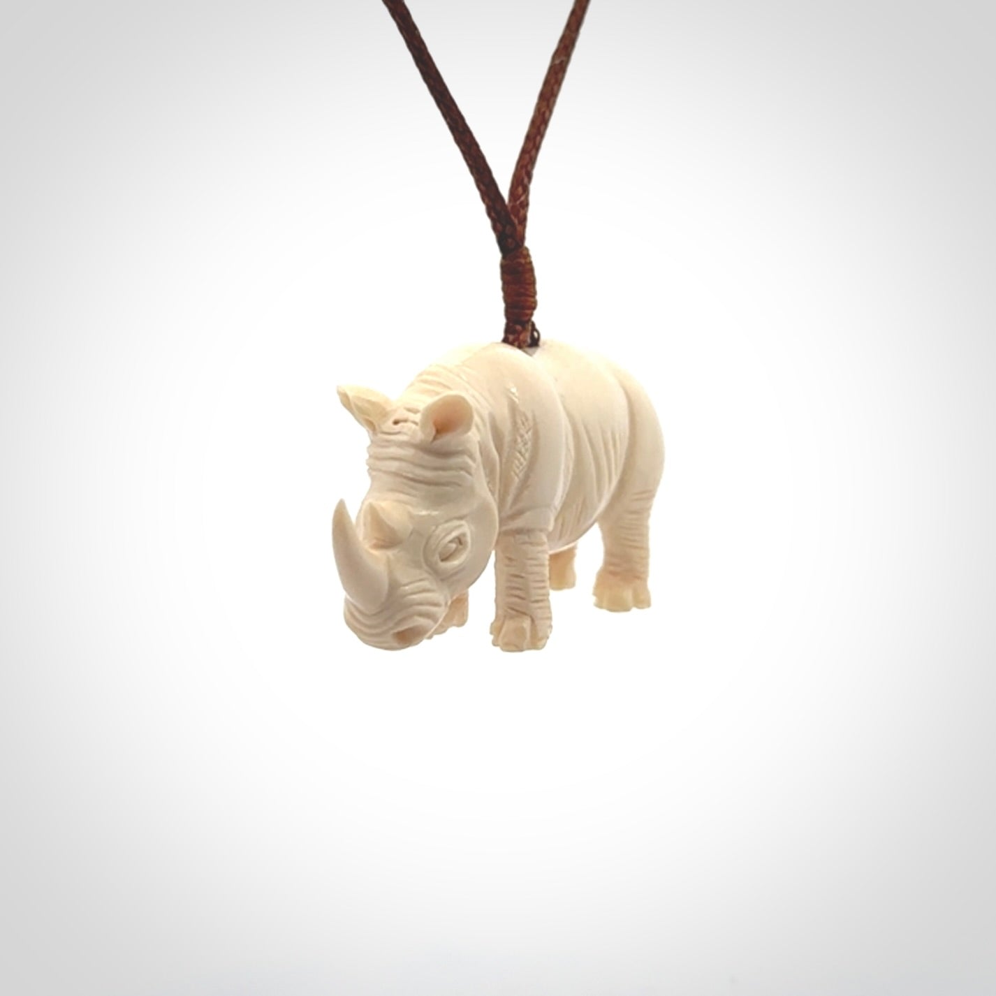 Hand carved Rhinoceros pendant. Carved from woolly mammoth tusk by NZ Pacific.