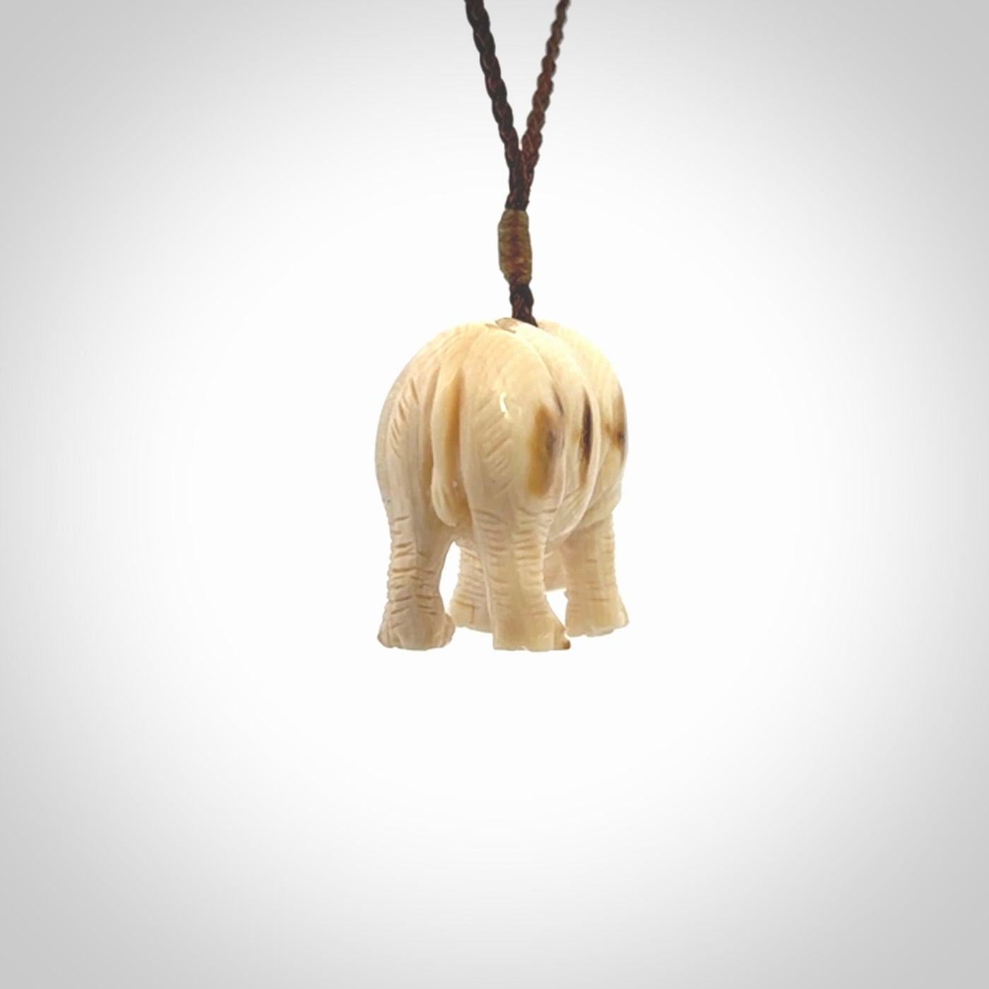 Hand carved Rhinoceros pendant. Carved from woolly mammoth tusk by NZ Pacific.