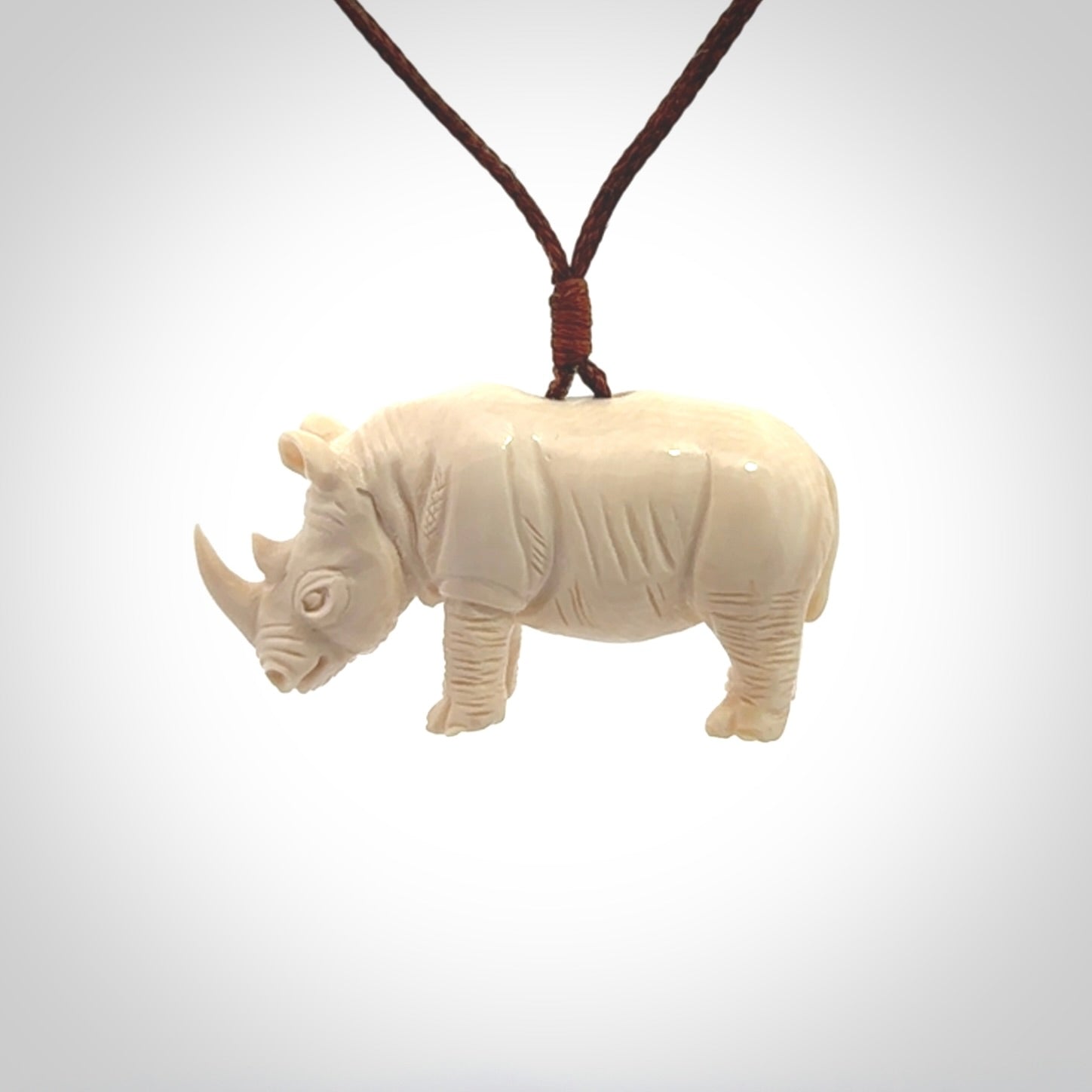 Hand carved Rhinoceros pendant. Carved from woolly mammoth tusk by NZ Pacific.