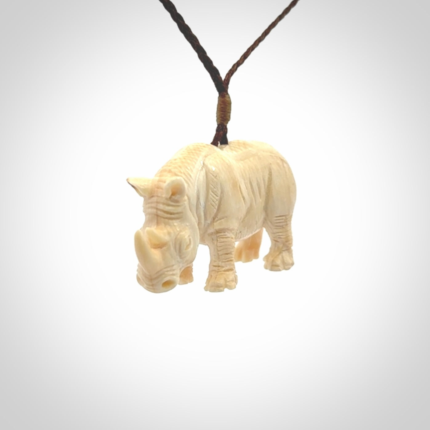 Hand carved Rhinoceros pendant. Carved from woolly mammoth tusk by NZ Pacific.