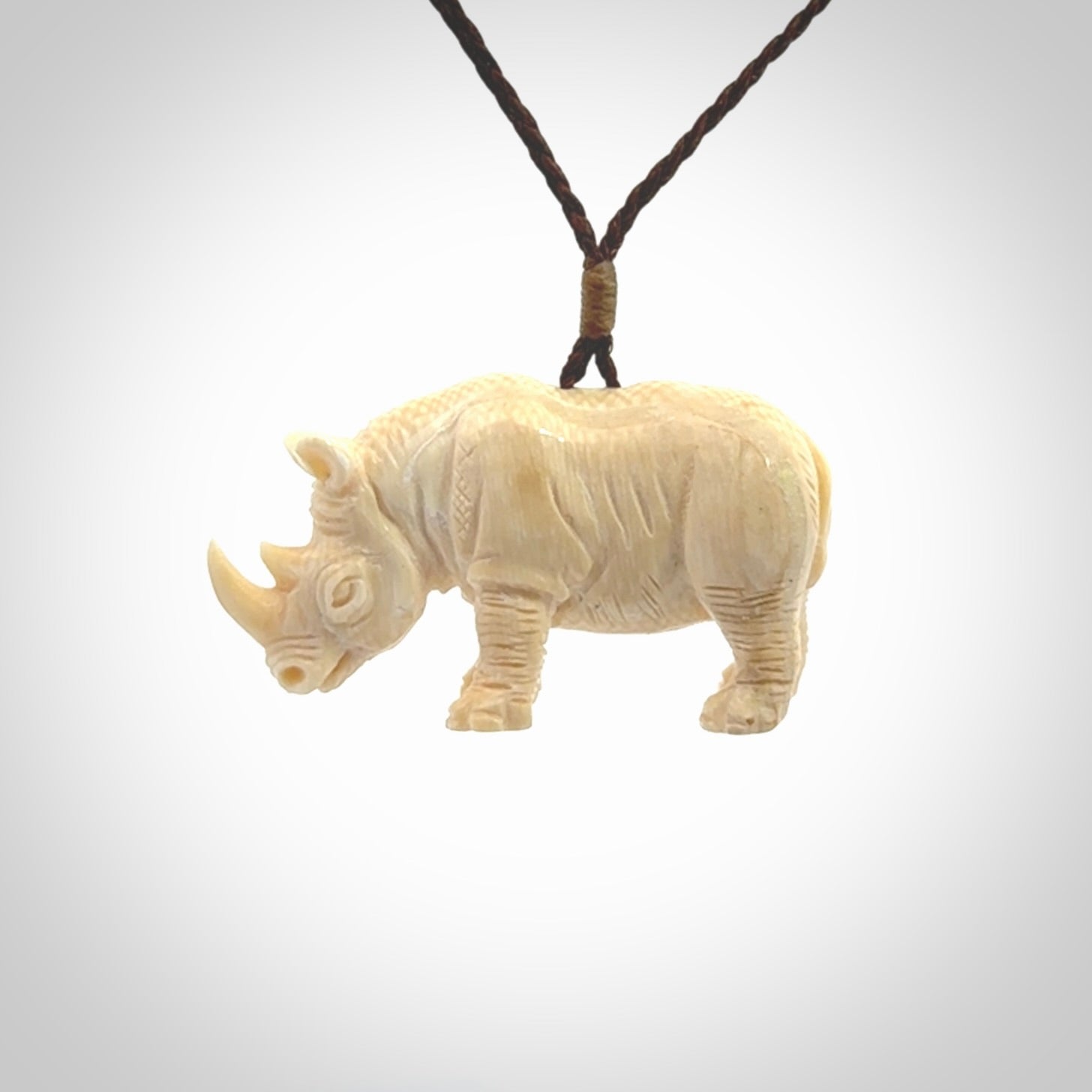 Hand carved Rhinoceros pendant. Carved from woolly mammoth tusk by NZ Pacific.