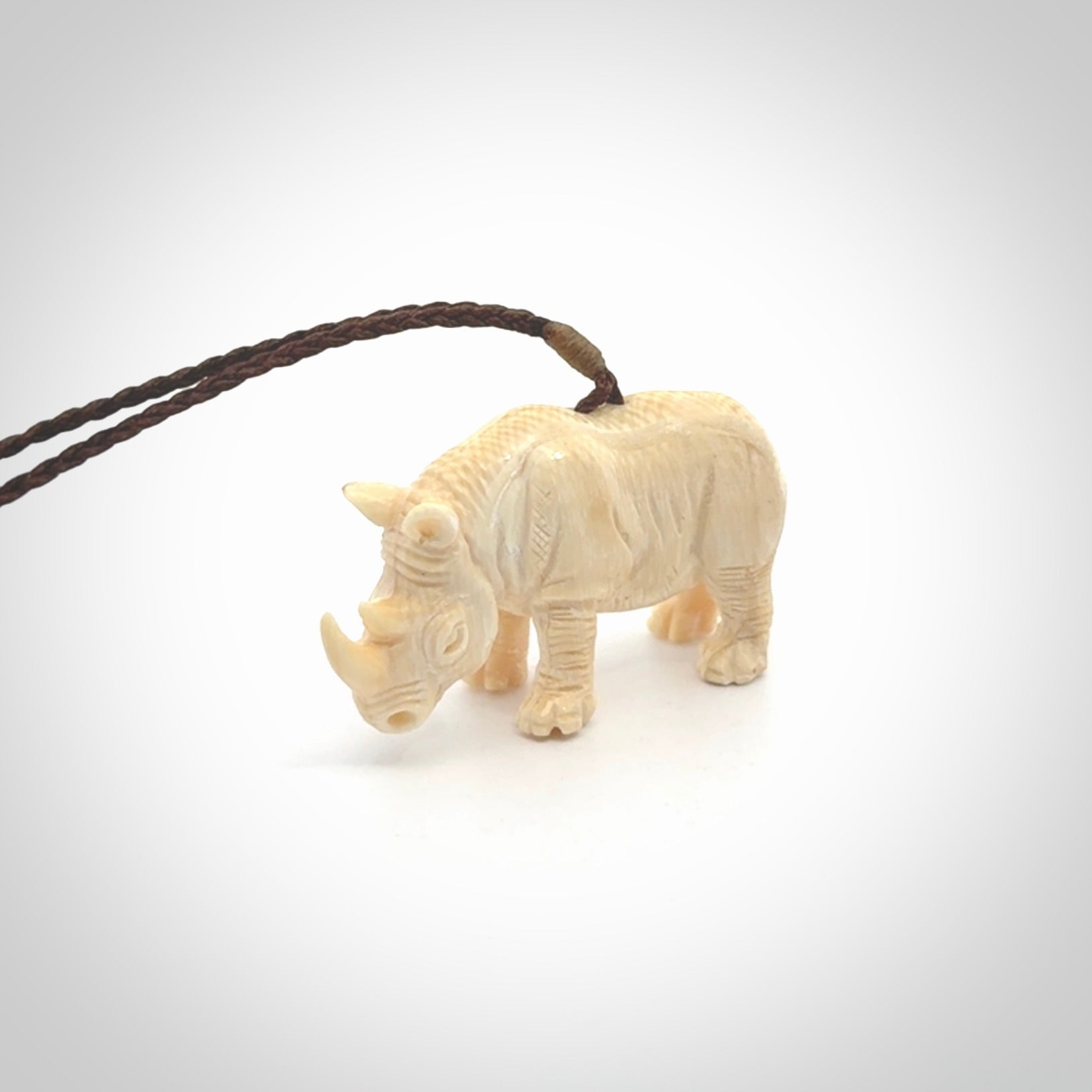 Hand carved Rhinoceros pendant. Carved from woolly mammoth tusk by NZ Pacific.