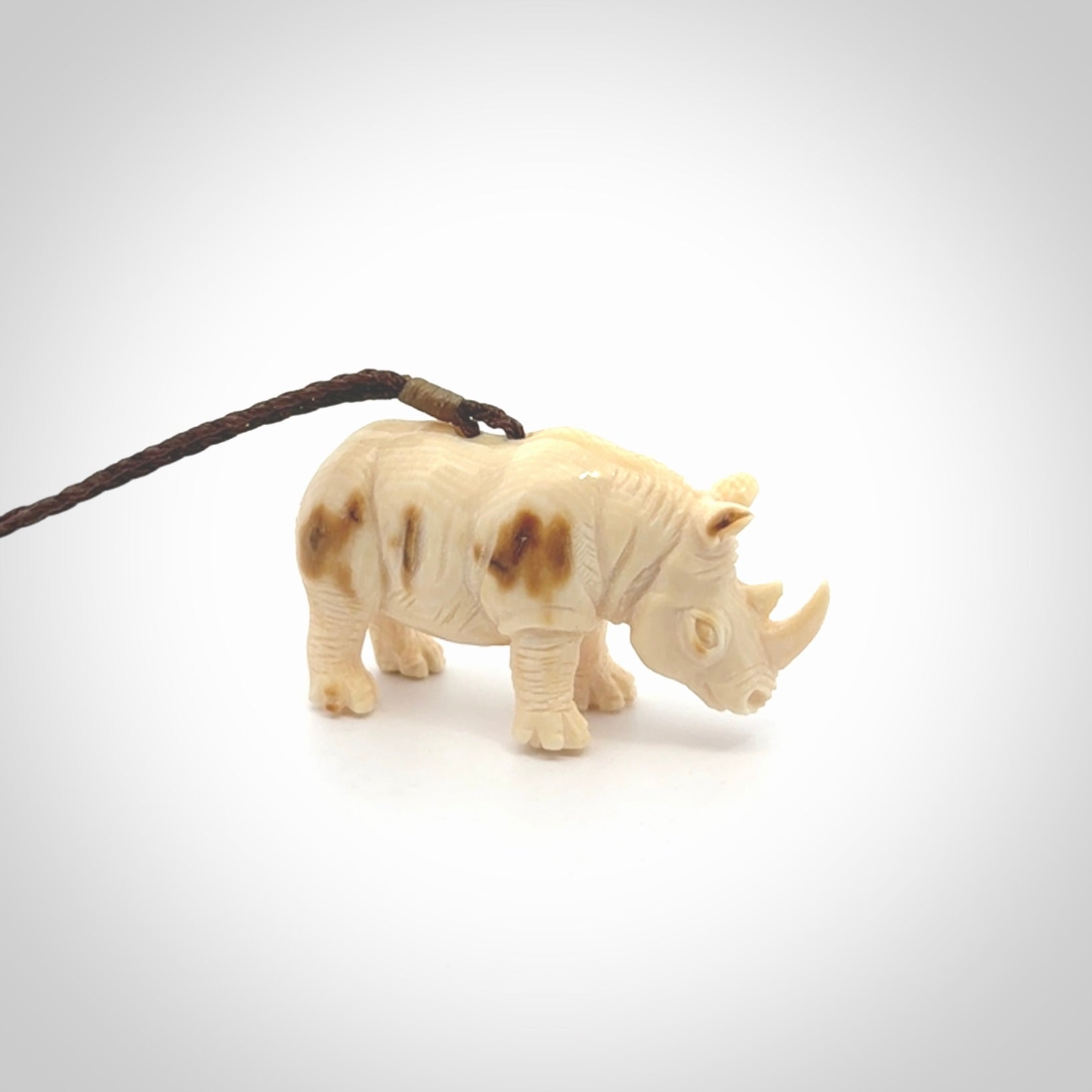 Hand carved Rhinoceros pendant. Carved from woolly mammoth tusk by NZ Pacific.
