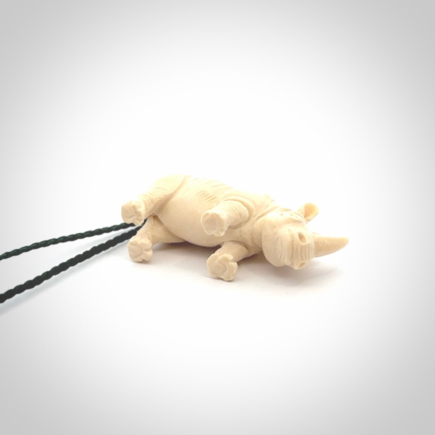 Hand carved Rhinoceros pendant. Carved from woolly mammoth tusk by NZ Pacific.