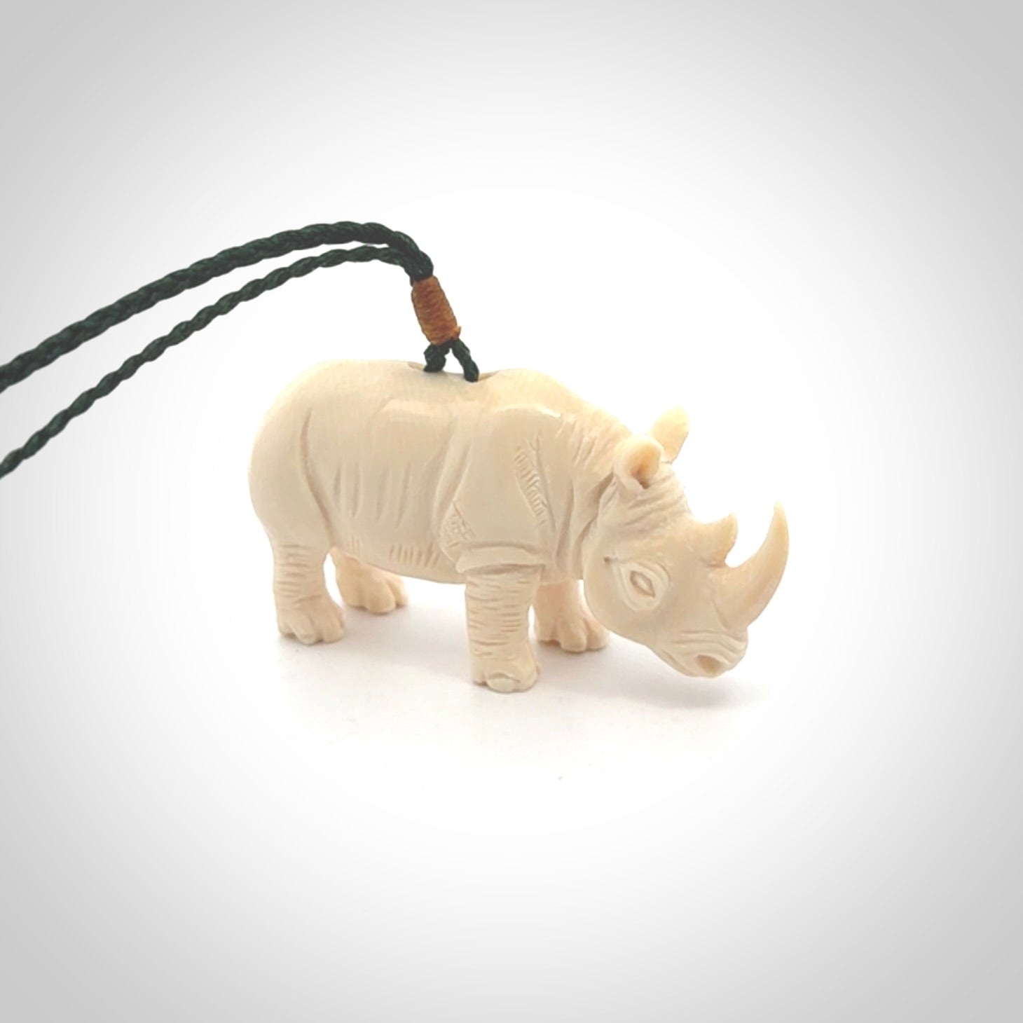 Hand carved Rhinoceros pendant. Carved from woolly mammoth tusk by NZ Pacific.